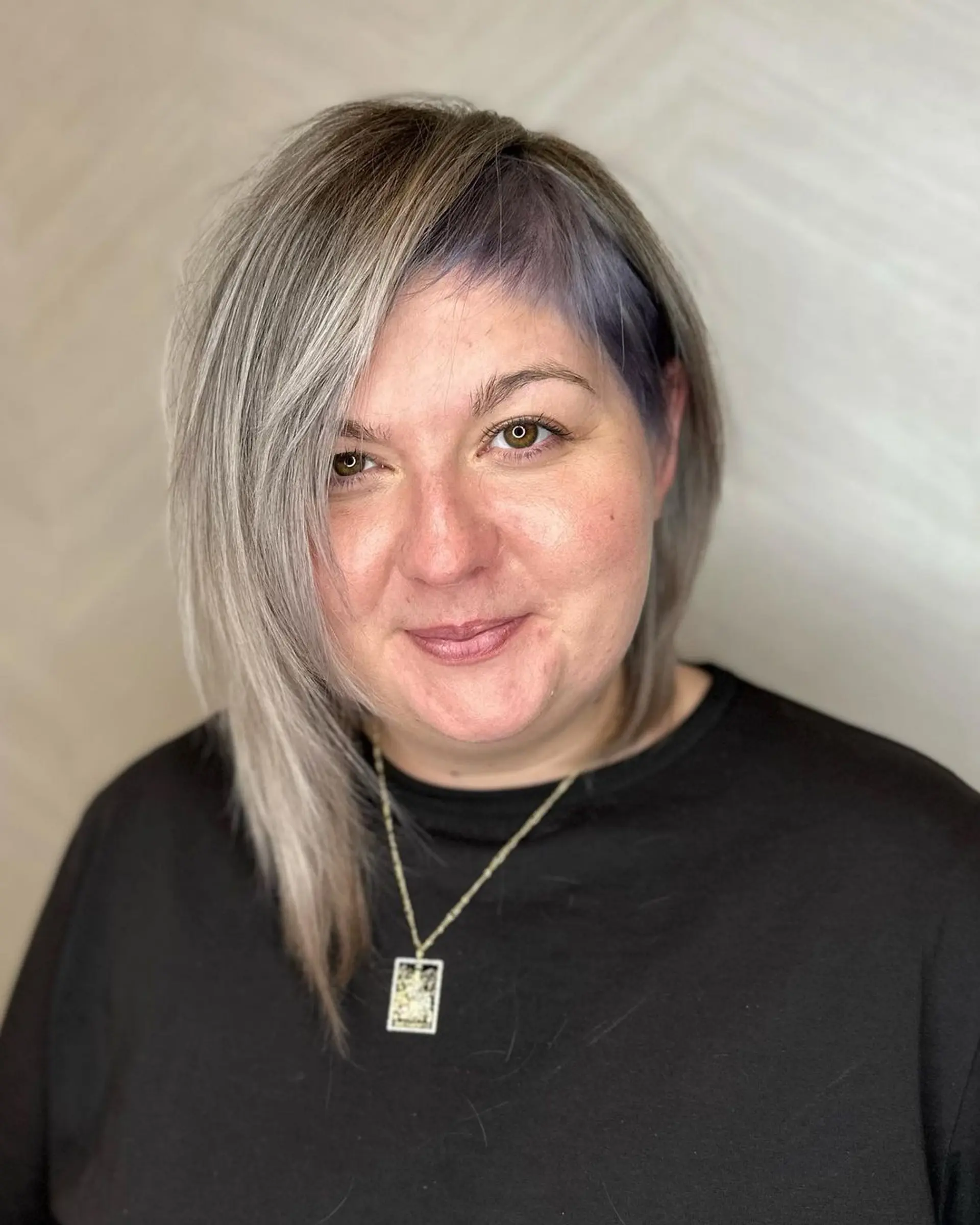 An asymmetrical, medium-length layered hairstyle with silver and lavender hues. Features straight hair with side-swept bangs and contrasting colors for a soft yet edgy finish.

Color by @simabeautynyc
Cut and style by @juliamannino_hair
 3
