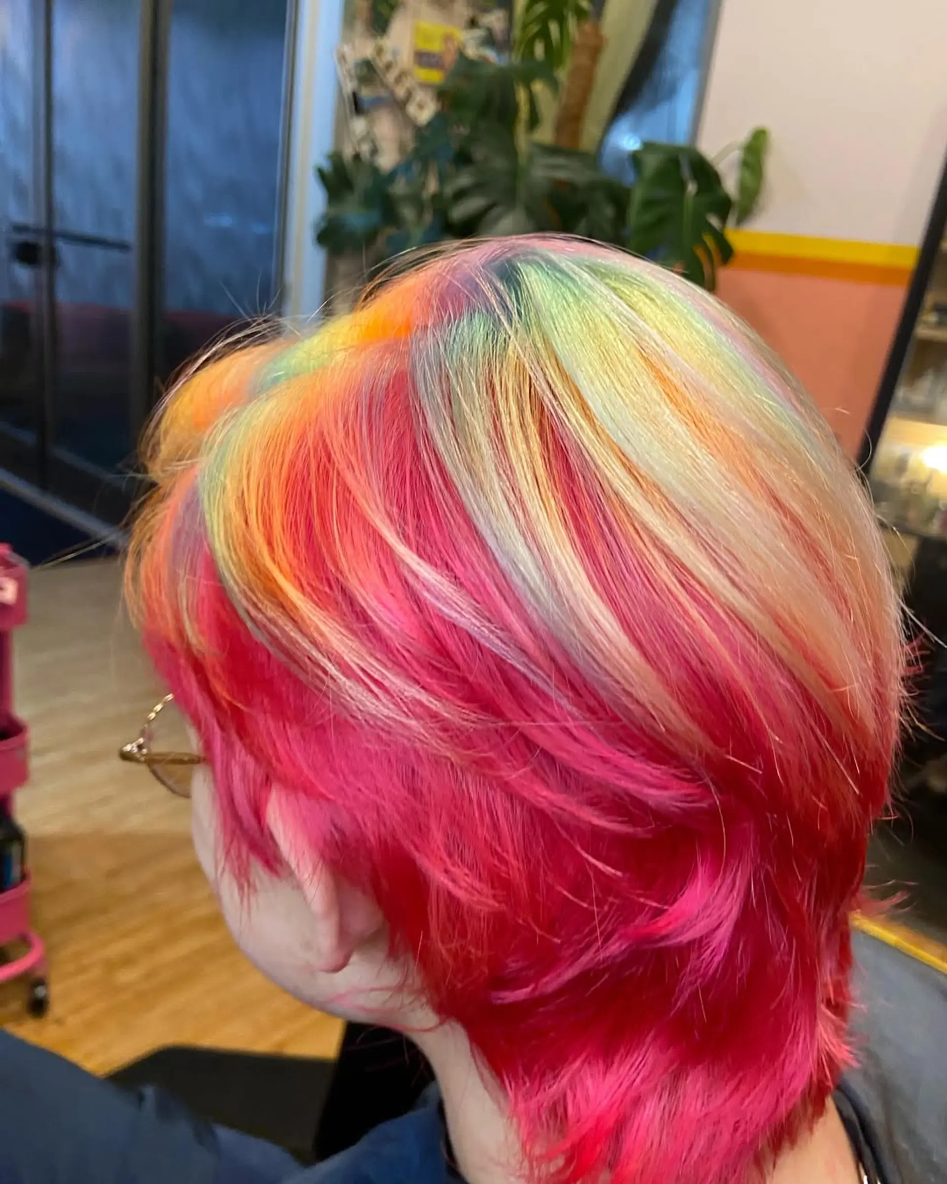 A short, straight hair design with vibrant rainbow colors layered for an edgy effect. 1