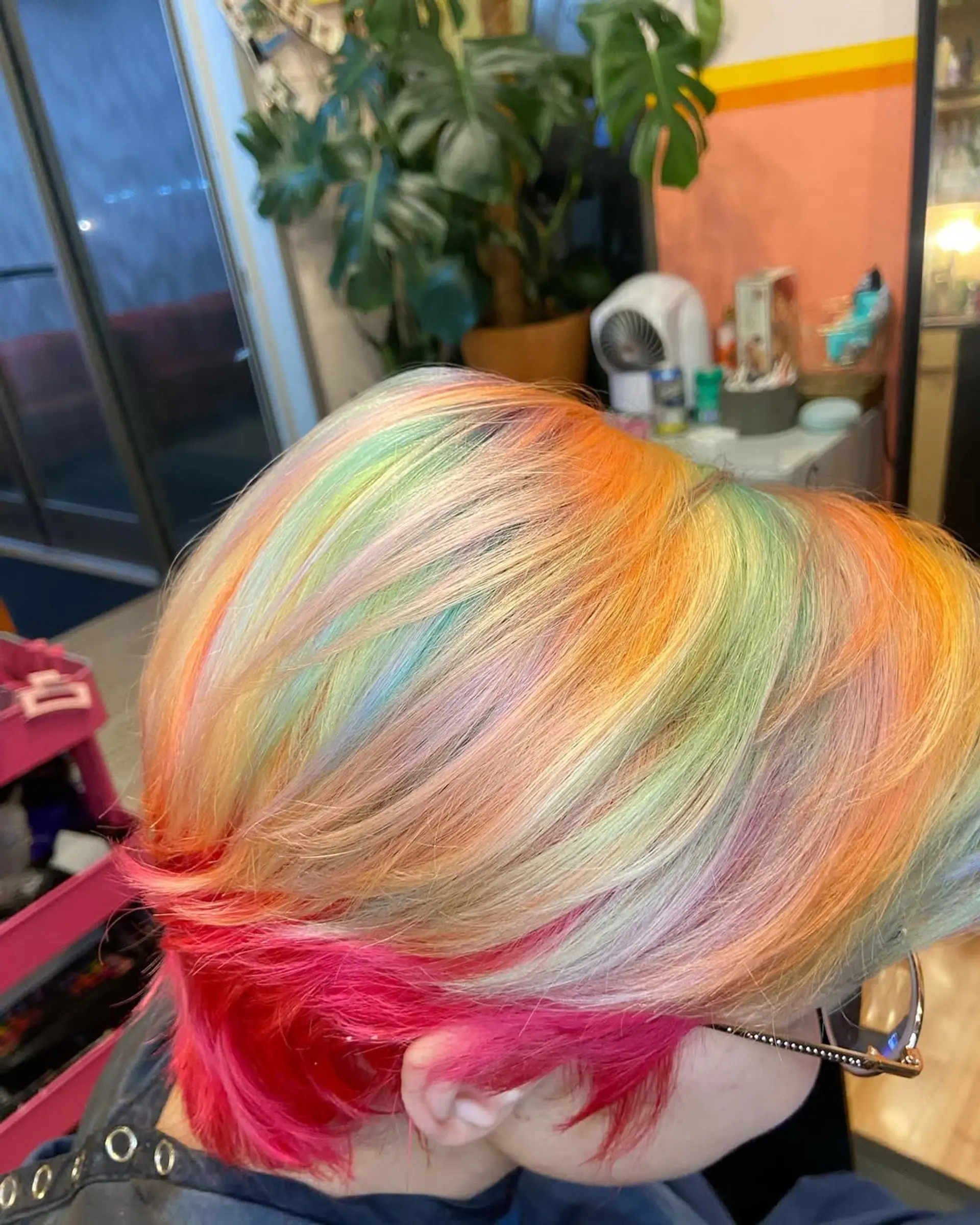 A short, straight hair design with vibrant rainbow colors layered for an edgy effect. 2
