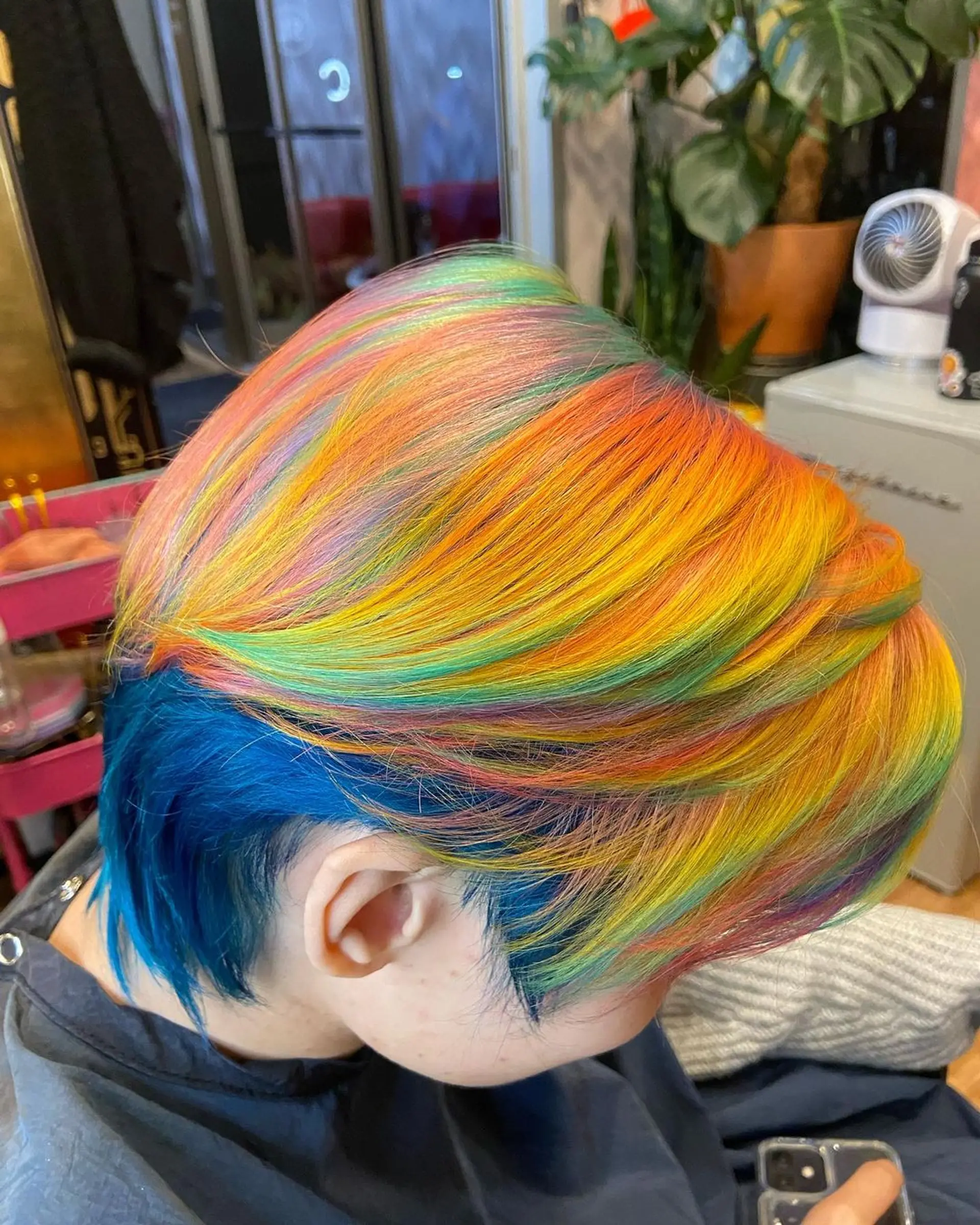 A short, straight hair design with vibrant rainbow colors layered for an edgy effect. 3
