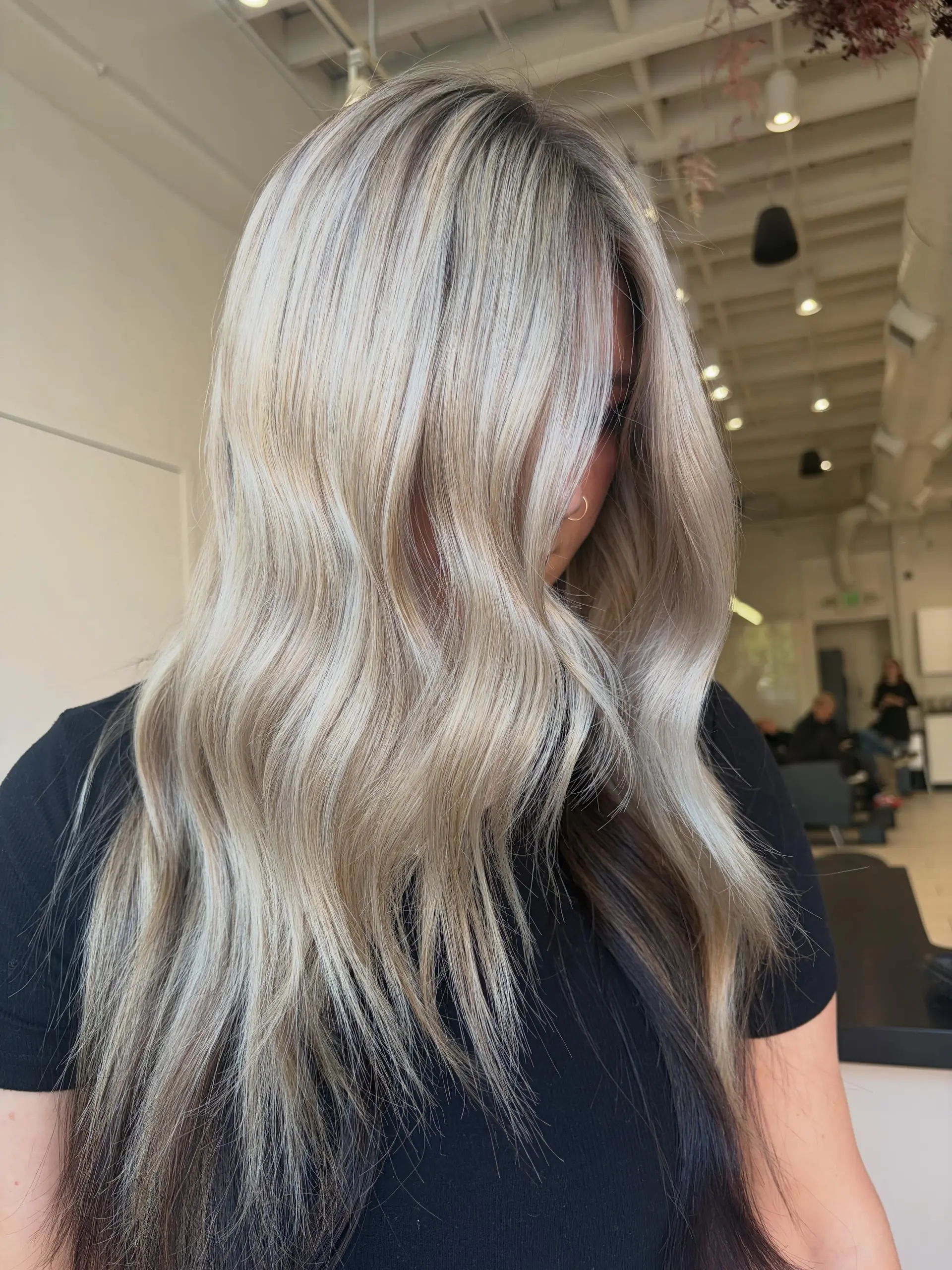 Long cool-toned dimensional blonde hair styled in soft, relaxed waves. 1