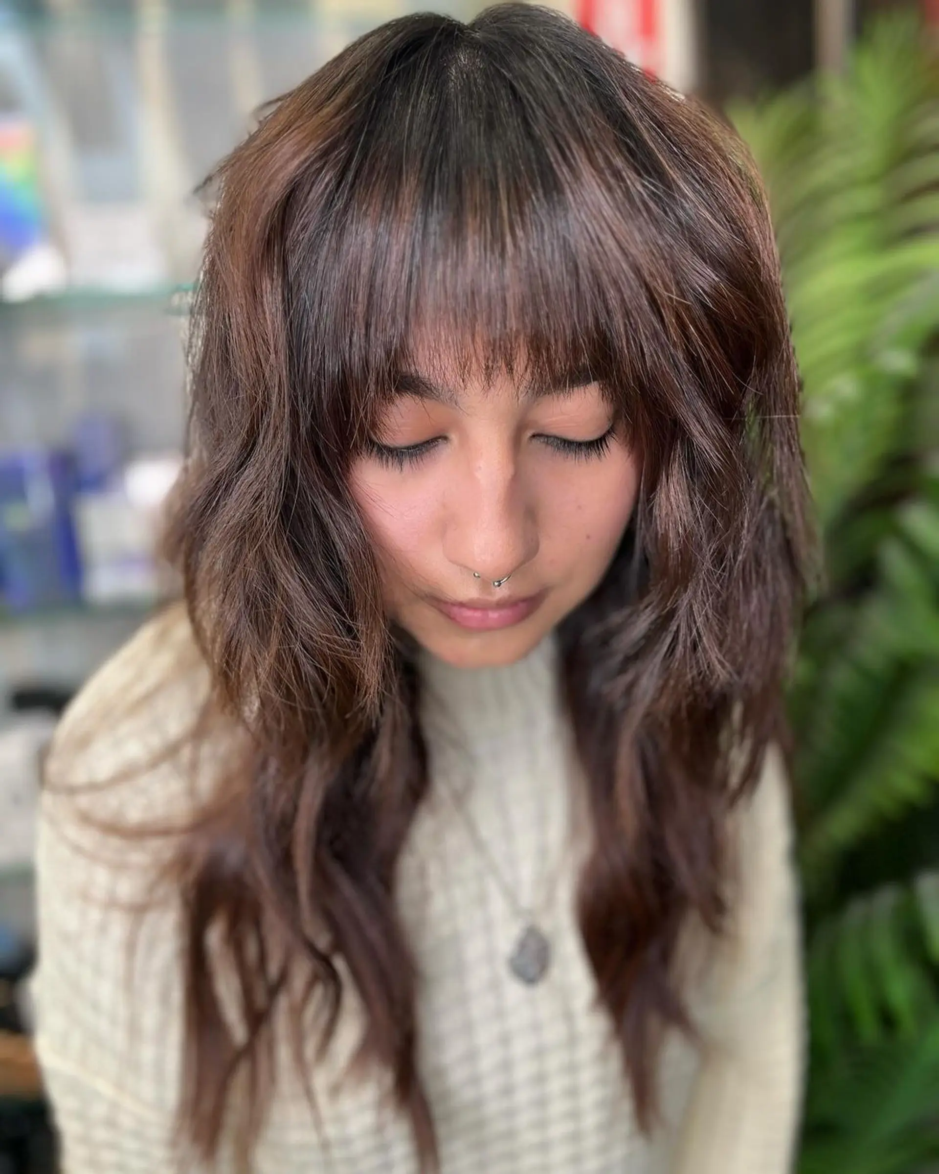 Chestnut brown, long, wavy hair with bohemian waves, textured layers, and fringe bangs, embodying an earthy, boho chic vibe with a soft texture. 2