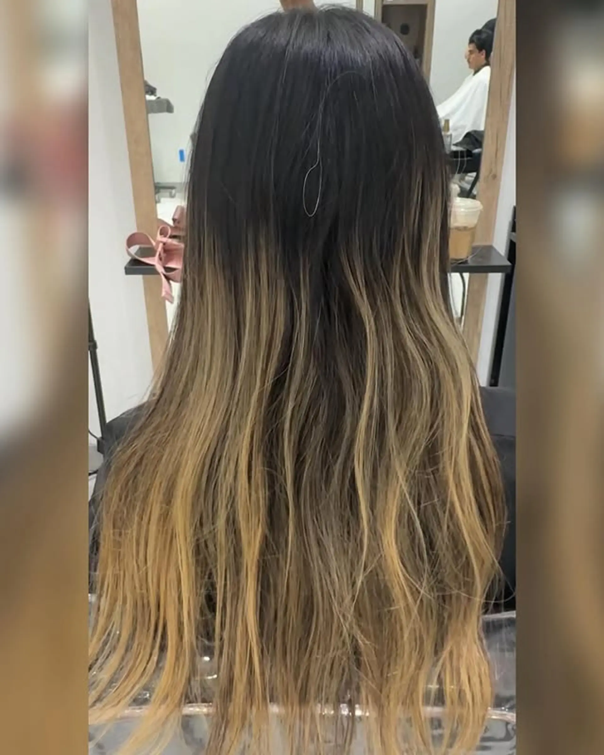 Long layered hairstyle with a brunette to blonde ombre. 1