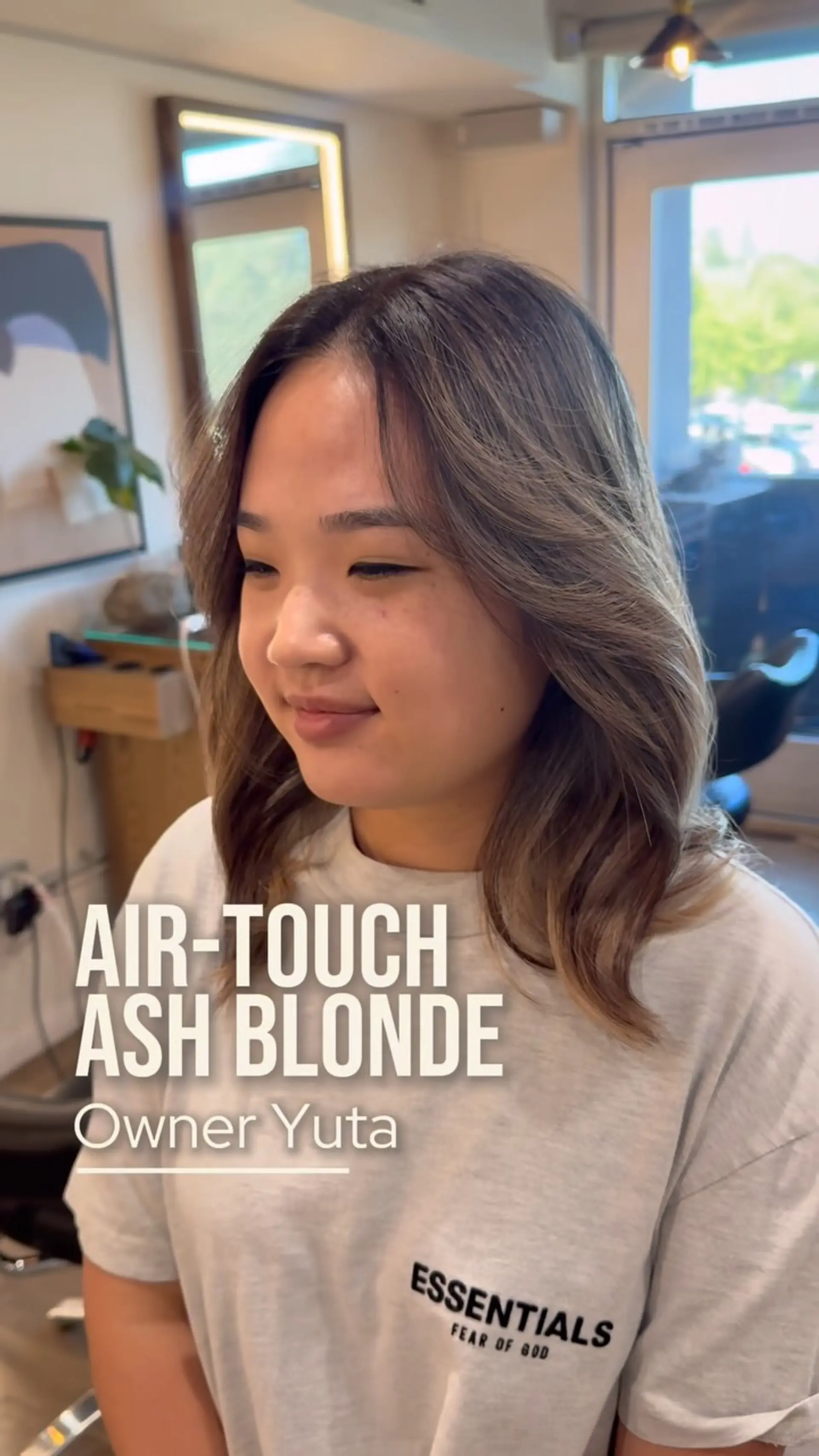 Medium-length layered lob featuring an airtouch ash blonde balayage styled with face-framing curtain layers and soft waves. 1