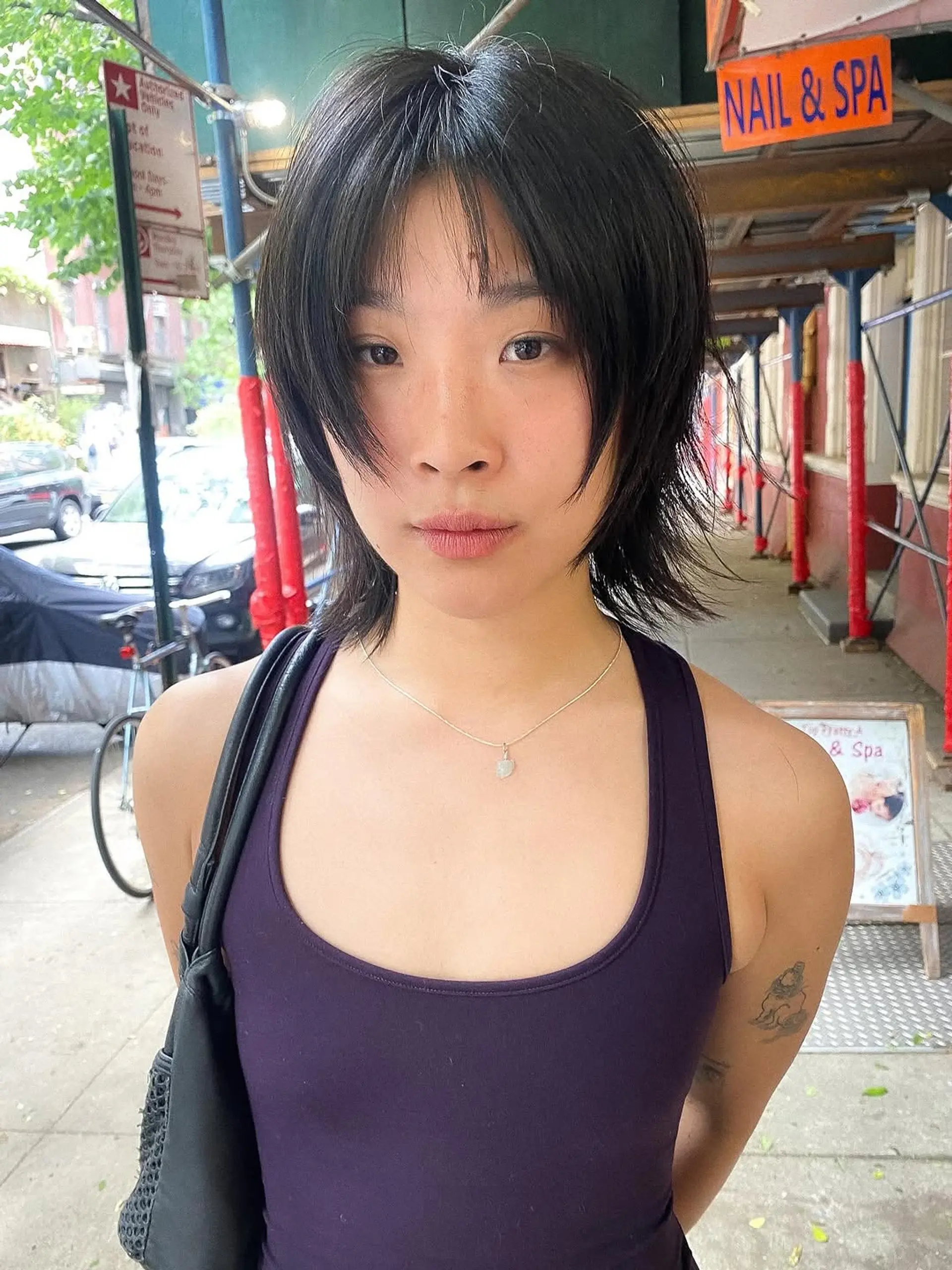 A modern, layered wolf cut with plenty of volume at the crown, wispy ends, and face-framing curtain bangs that blend seamlessly into the shag silhouette. 1
