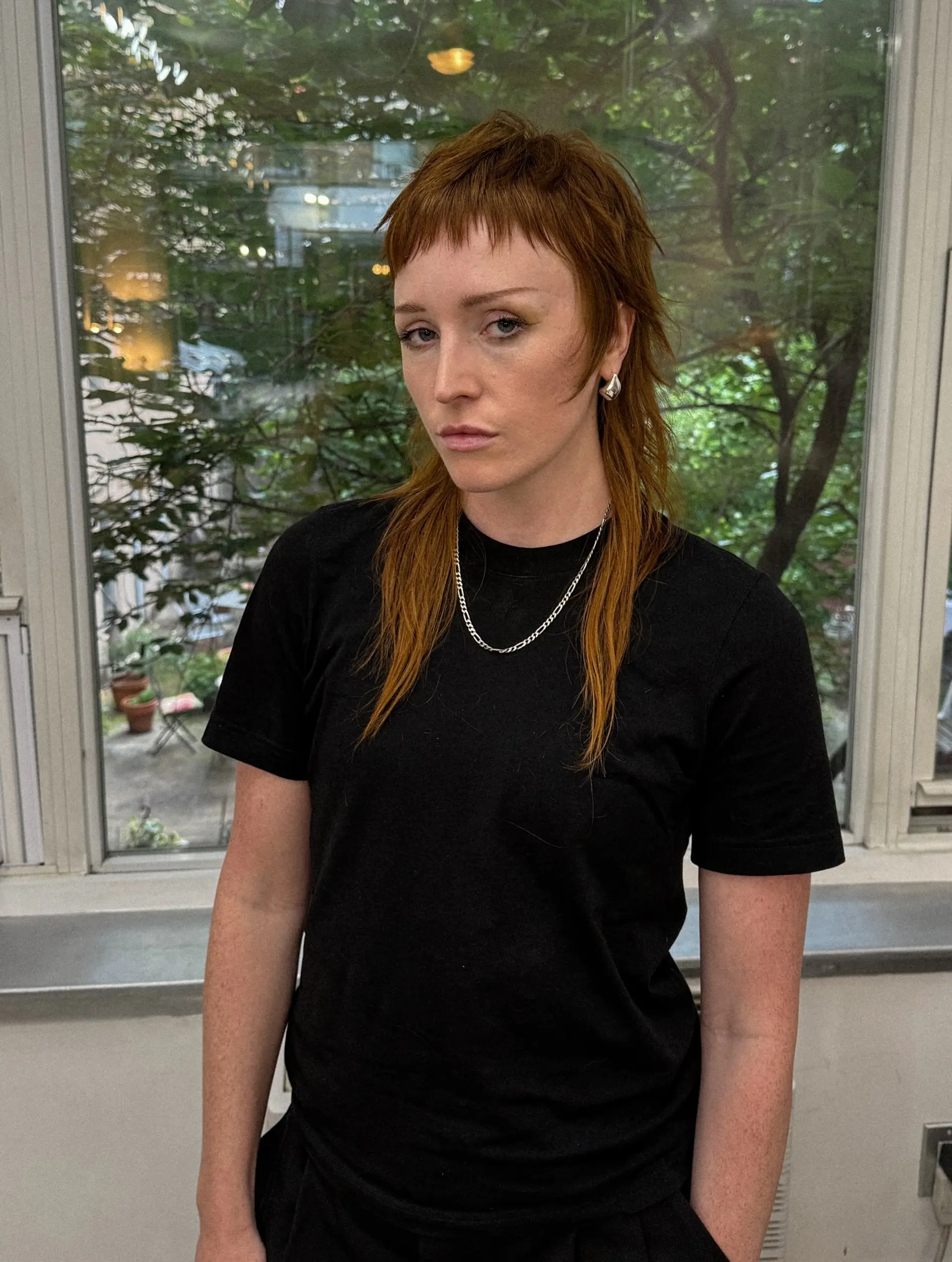 A shaggy mullet with short, choppy micro bangs. The style is heavily layered for texture and movement. 3