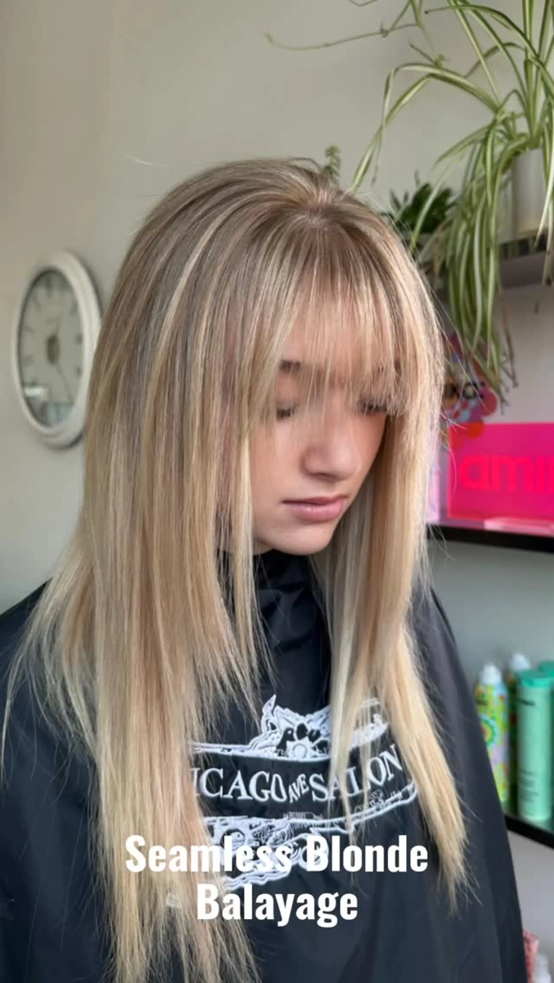 Straight, long dimensional blonde hair featuring a seamless balayage, soft root melt, and wispy eye-skimming bangs. 1
