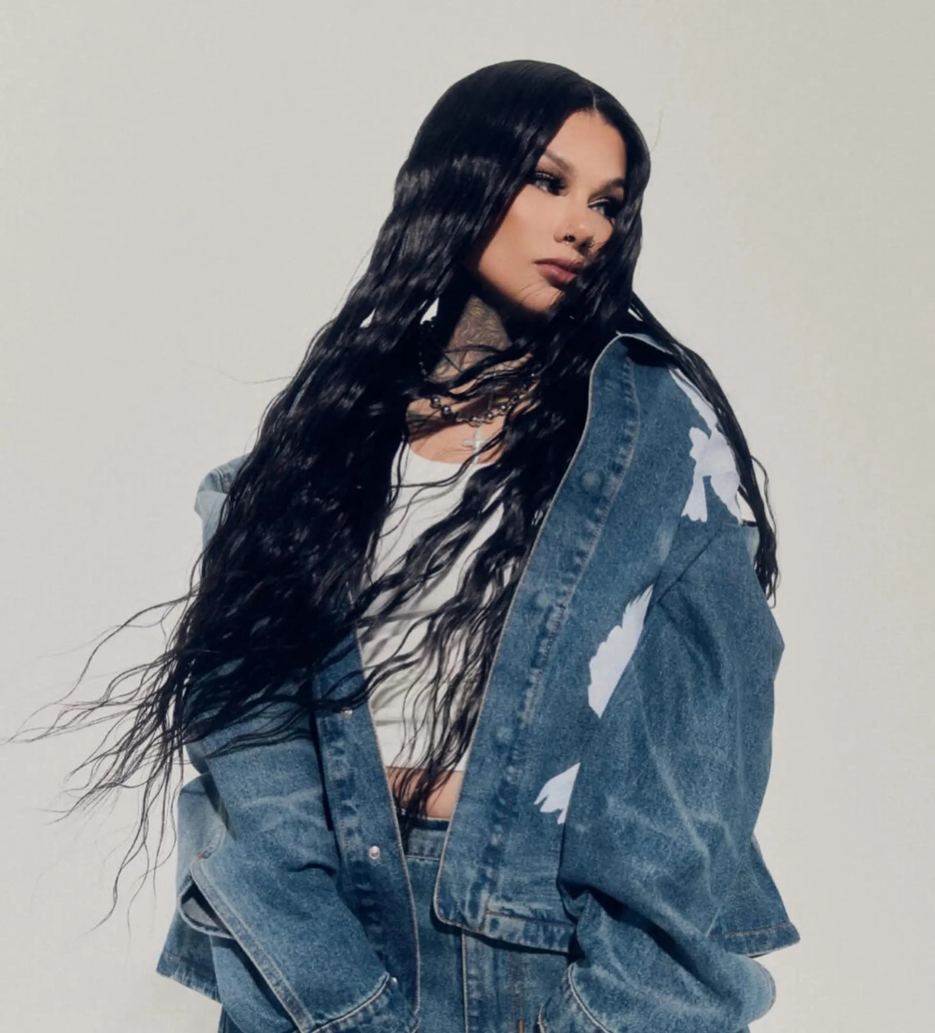 Extra-long jet black hair styled into deep, textured crimped mermaid waves with a sharp center part. 1