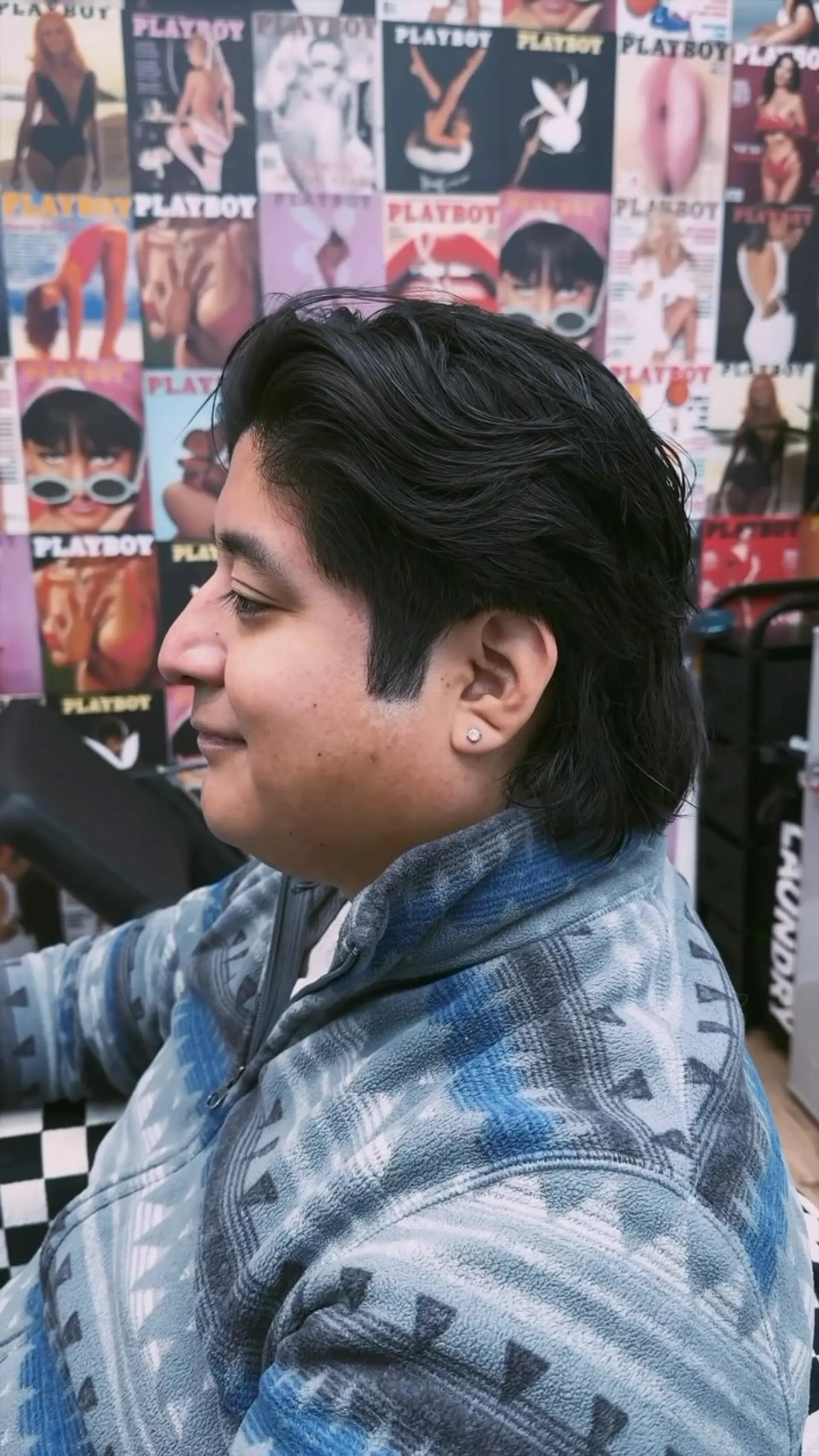 A textured razor haircut styled swept back with natural wavy flow and length left through the back. 1