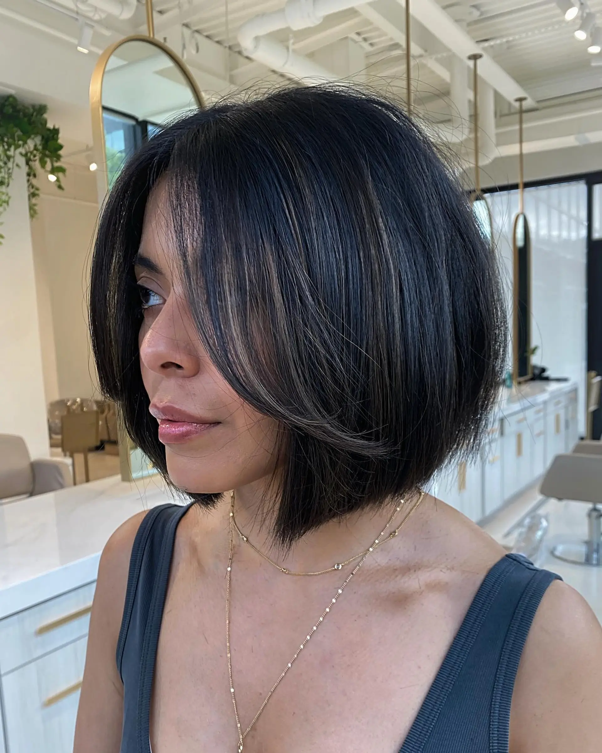 A textured chin-length bob featuring soft face-framing layers and subtle dimensional babylights. 1