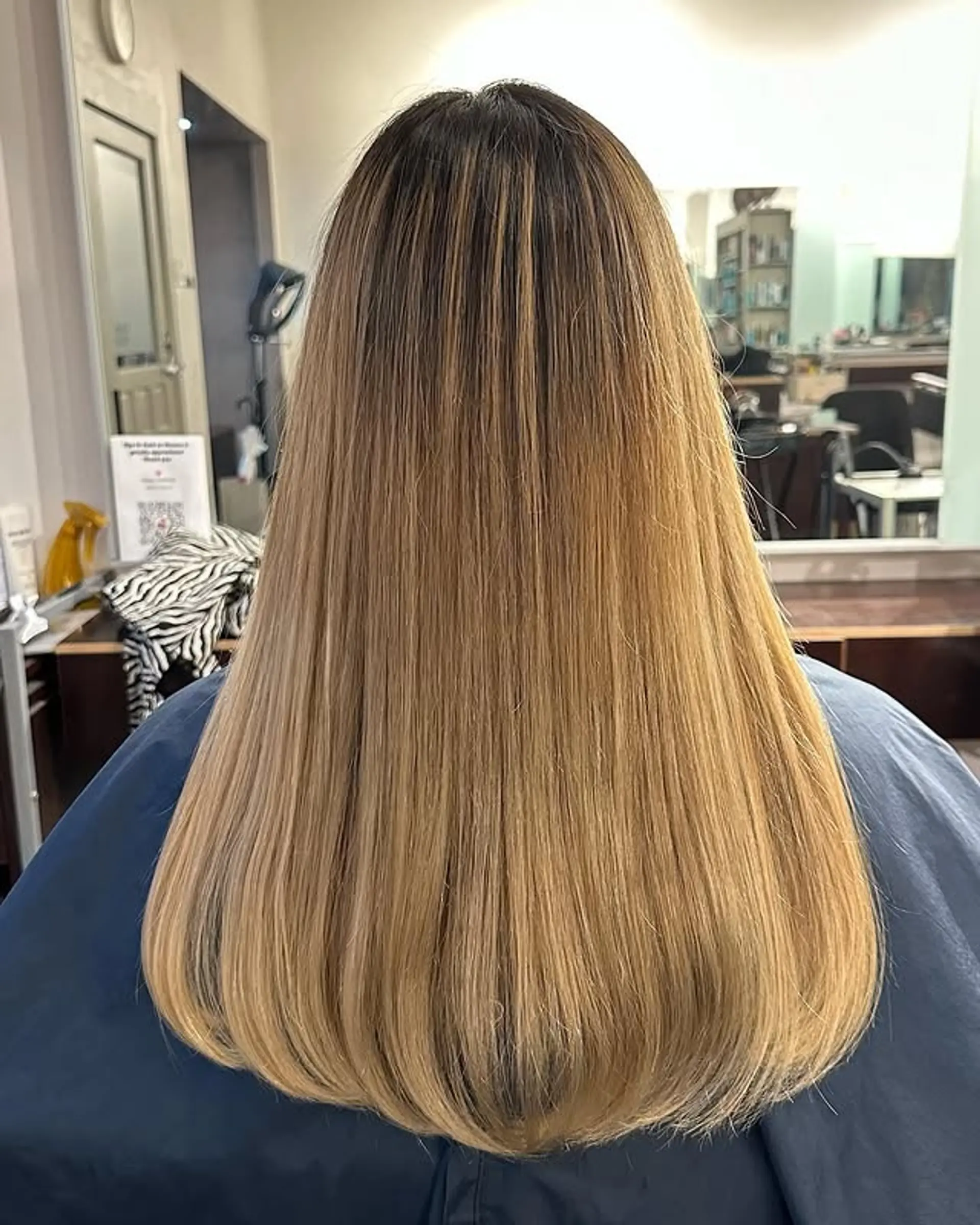 Long, layered, straight hair with a golden blonde balayage. 1
