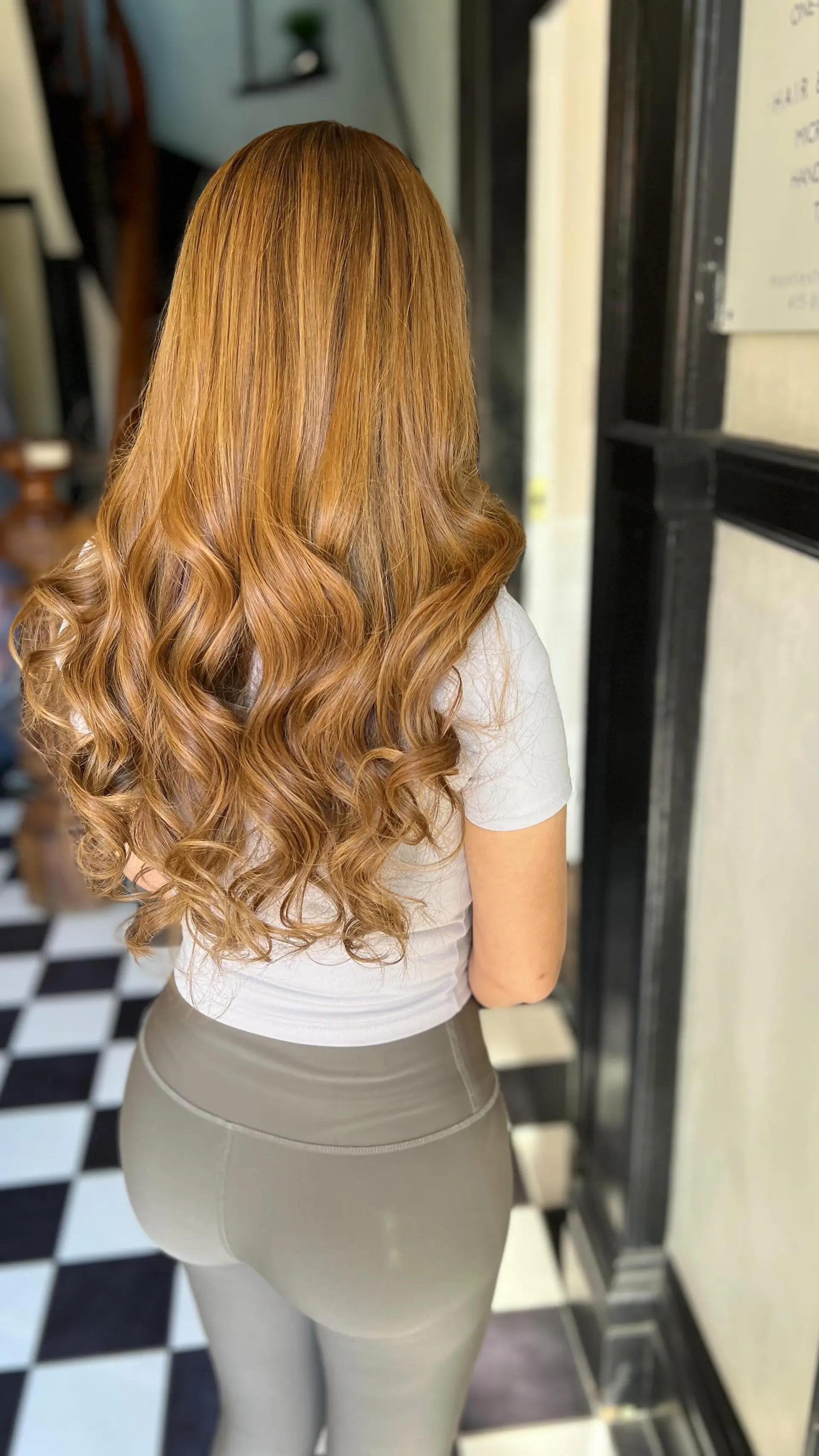 Long, flowing caramel honey hair featuring seamless I-tip extensions styled into voluminous, glossy waves. 1