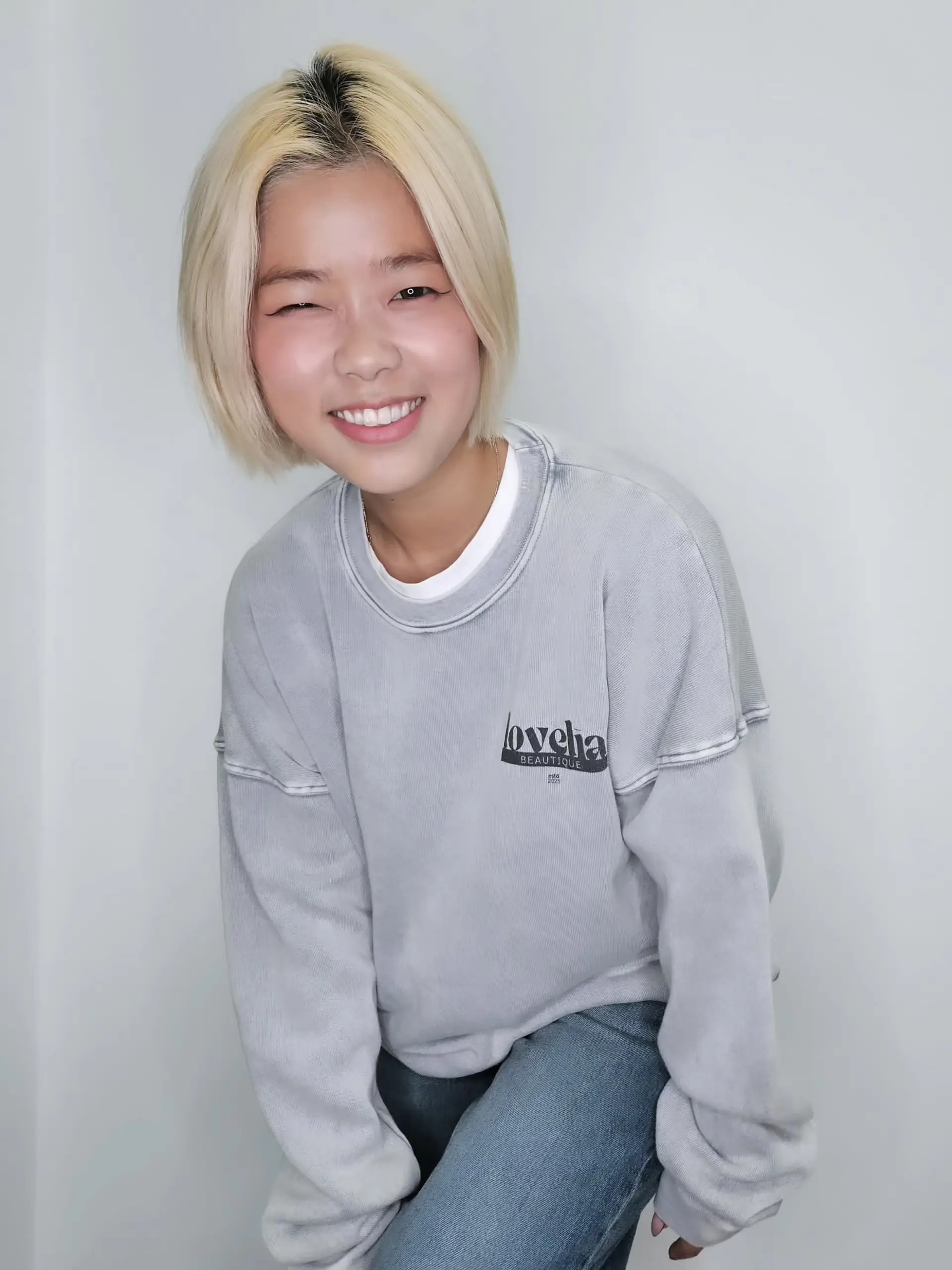 A sleek, chin-length platinum blonde bob styled with a middle part. 1