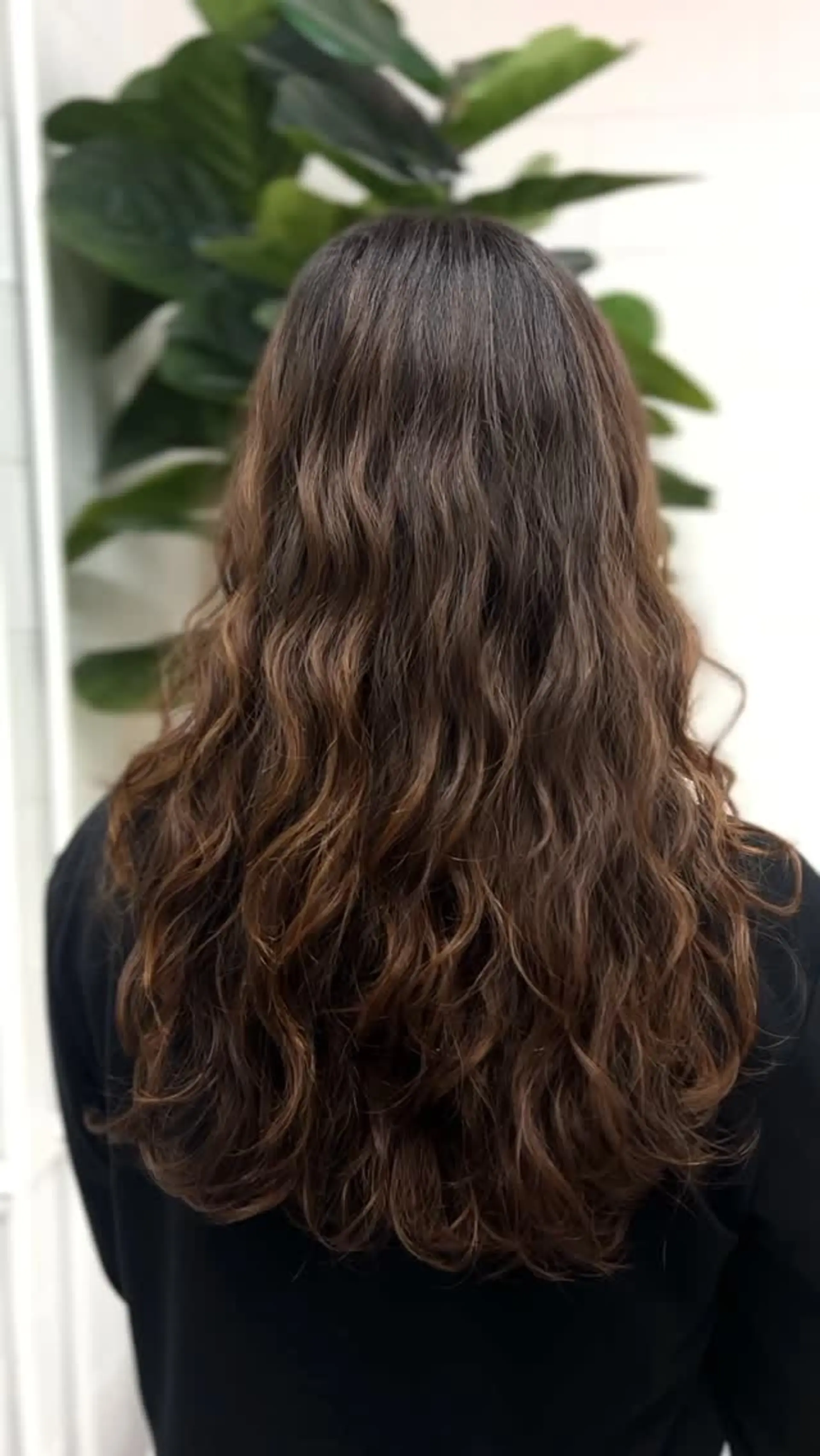 Long brunette hair styled in loose, natural waves created with a digital perm and dried with a diffuser. 1