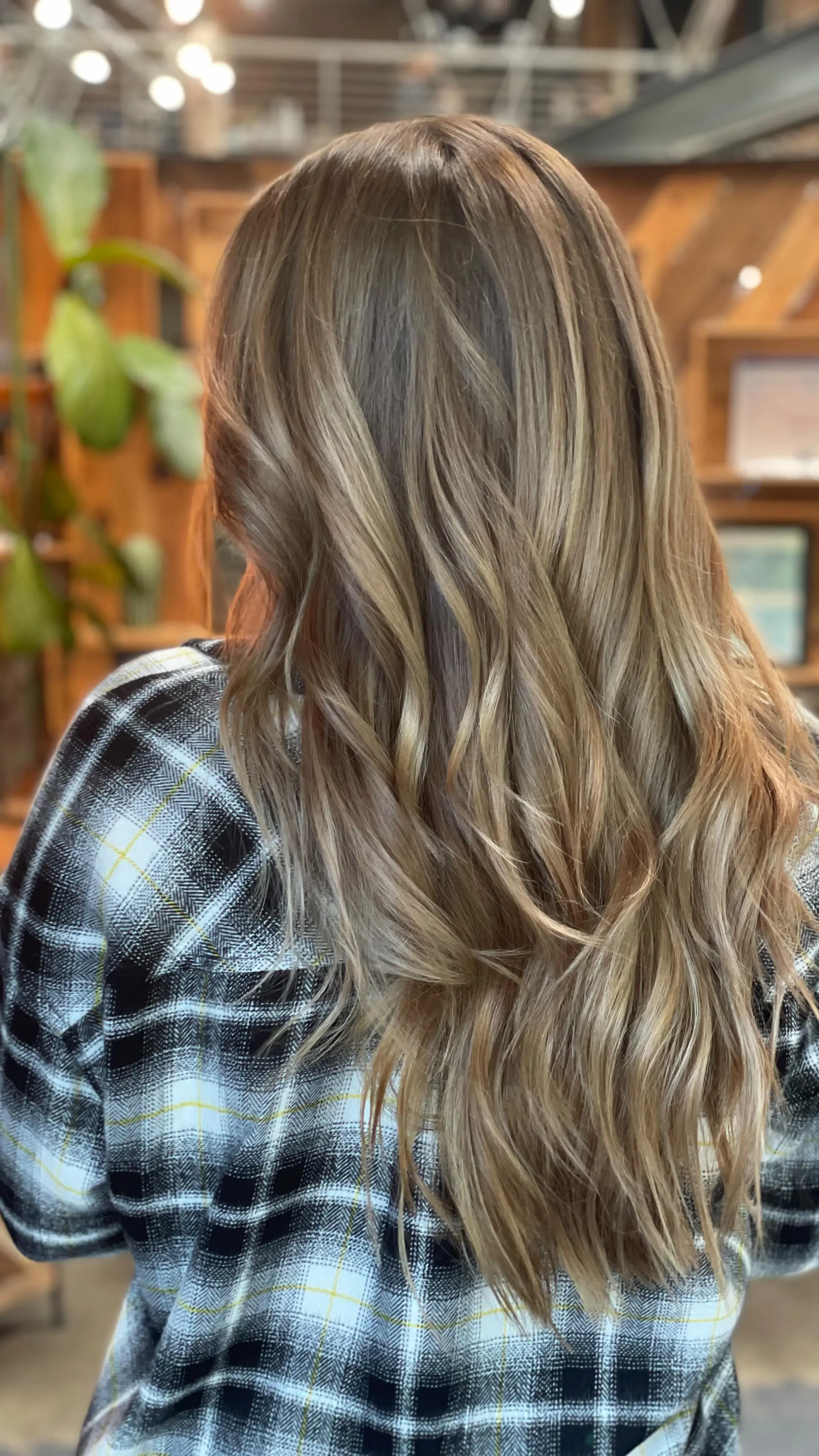 Long hair featuring a multi-dimensional ash blonde and light brown blend styled into soft, flowing waves. 1