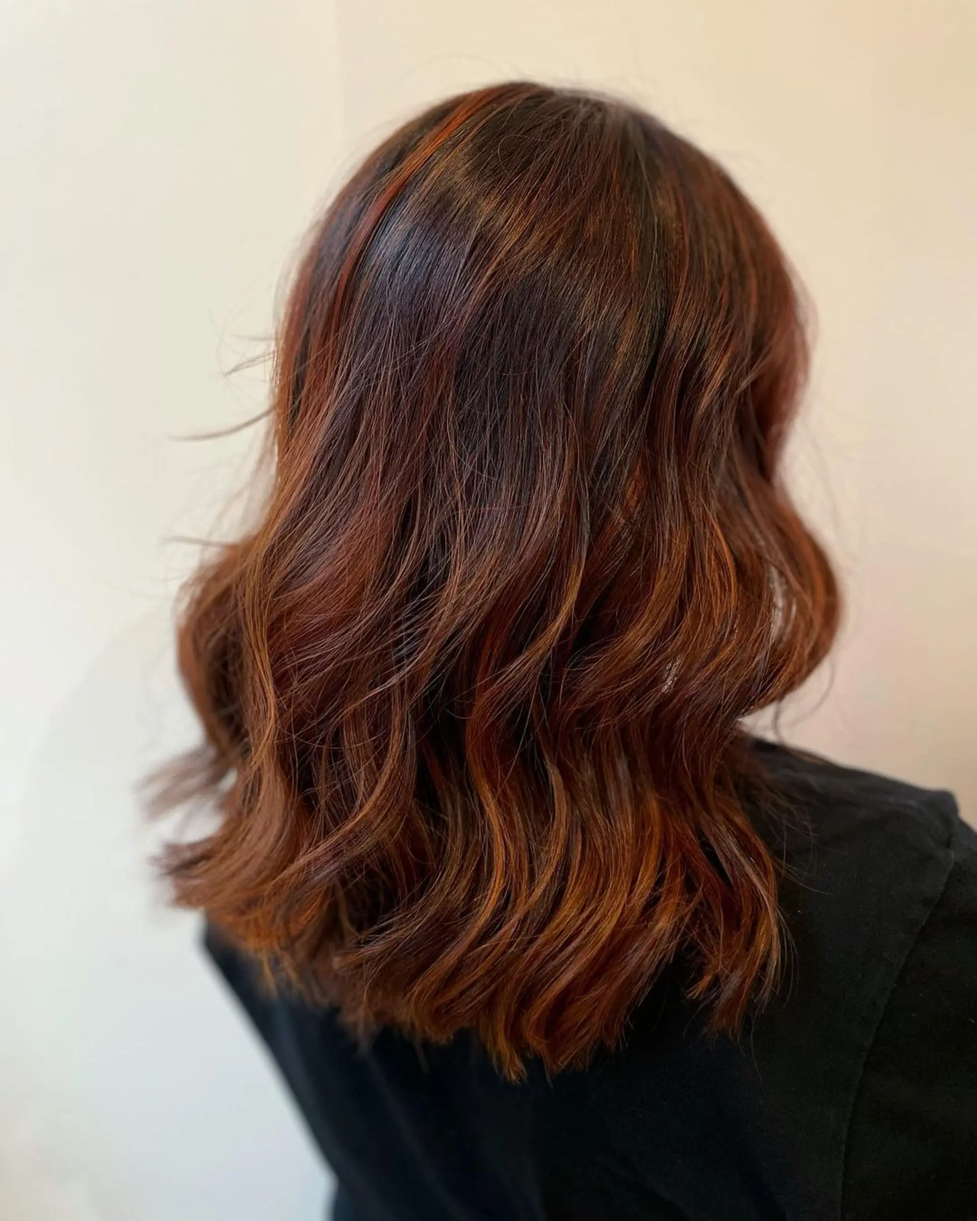 Medium-length wavy hair with a mix of copper, auburn, and rich brown hues, featuring soft waves and subtle layering. 1