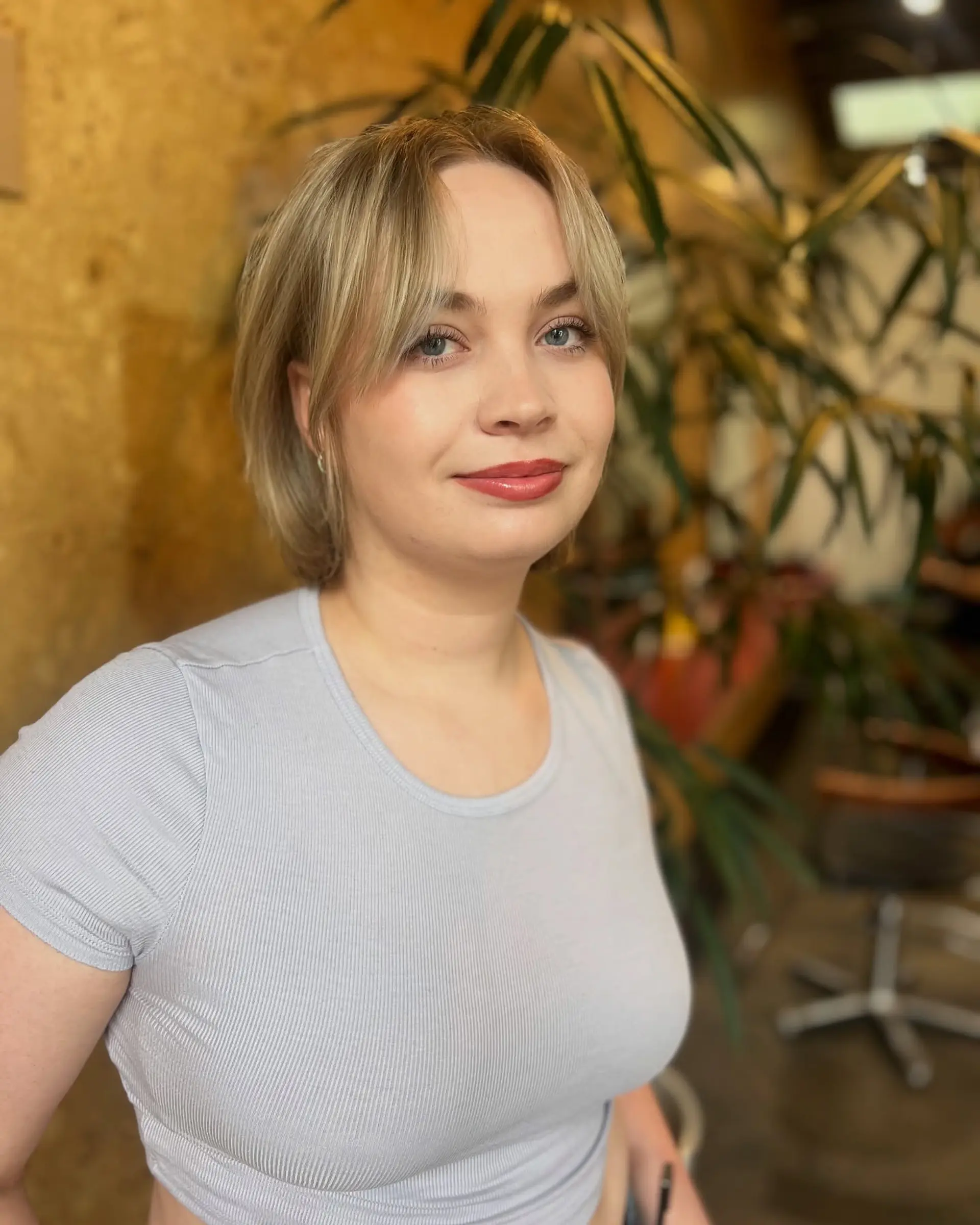A soft blonde short bob with subtle curtain bangs. 1