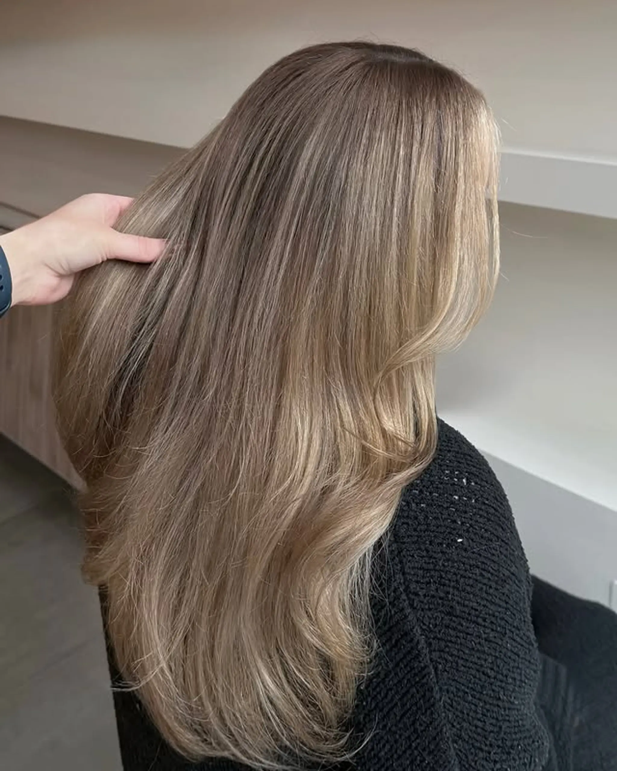 Long, layered bronde balayage with soft layers and face-framing pieces.
