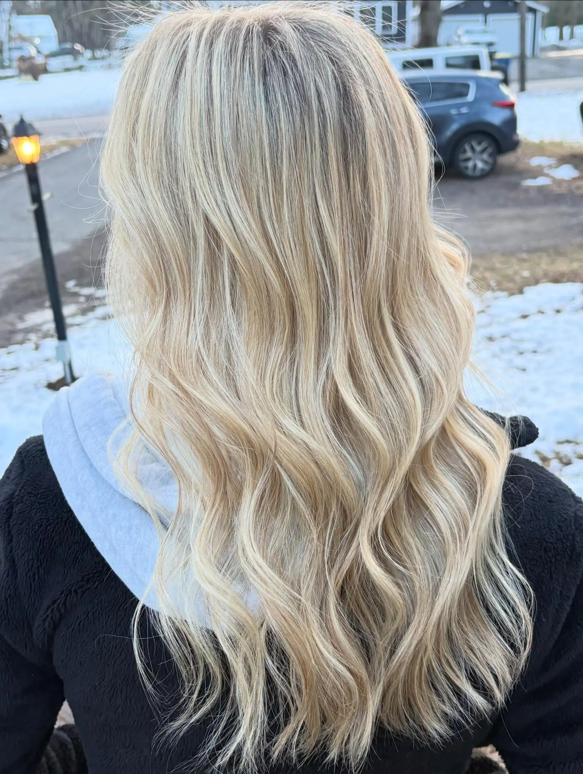 Long dimensional blonde hair styled in soft, loose waves. 1