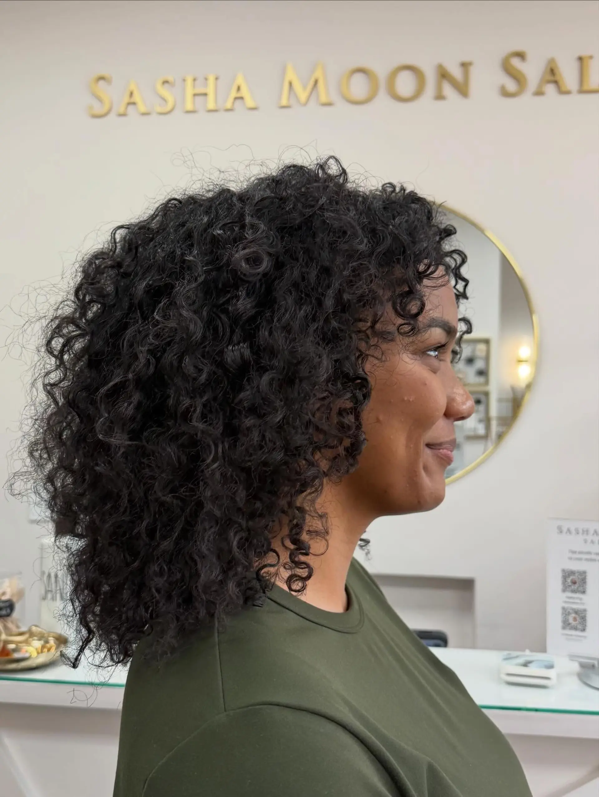 A medium-length rounded cut designed to enhance natural volume and definition in tightly curled and coily hair. 1