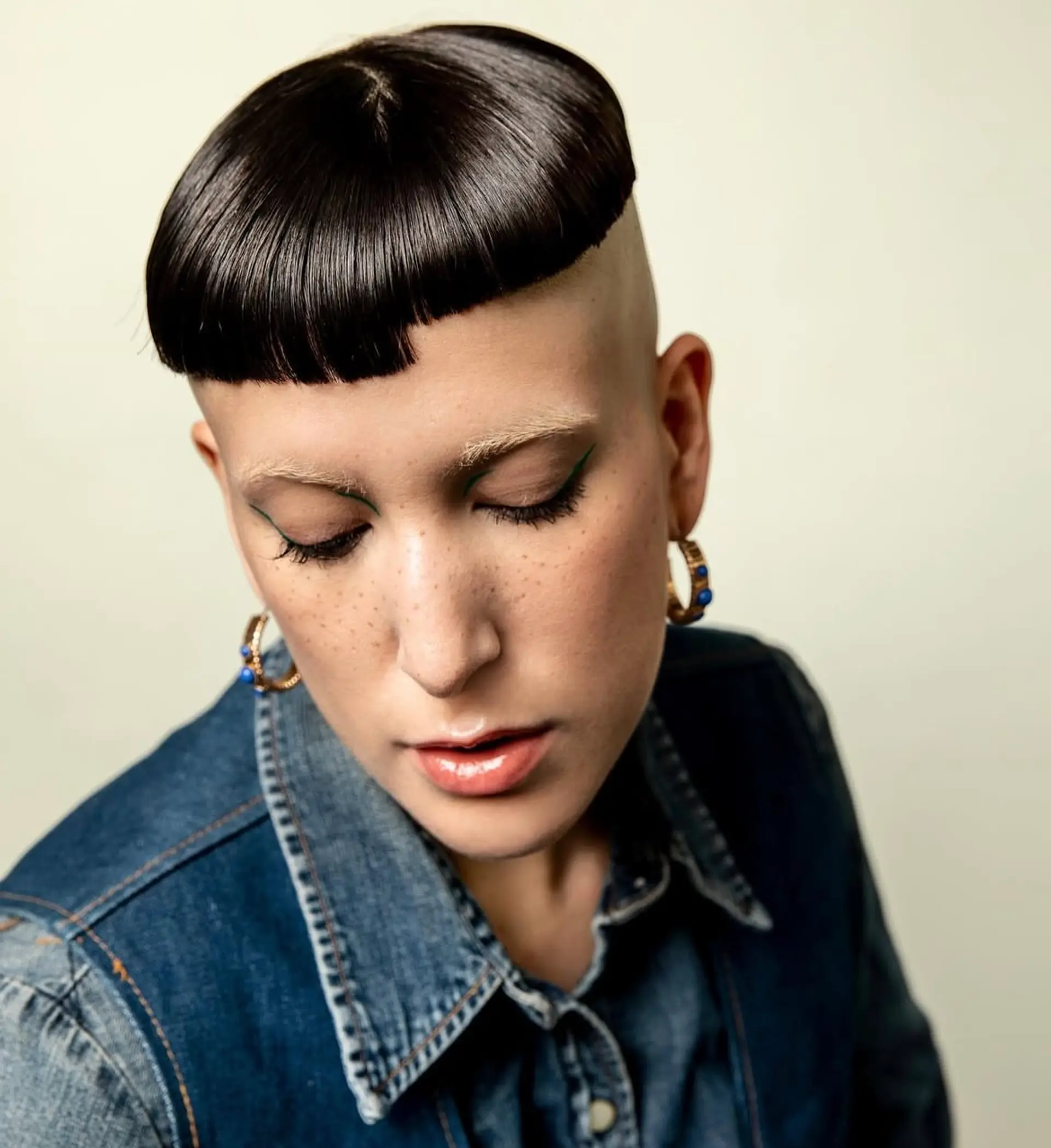 A asymmetrical bowl cut with closely shaved sides for an edgy and modern look. 1