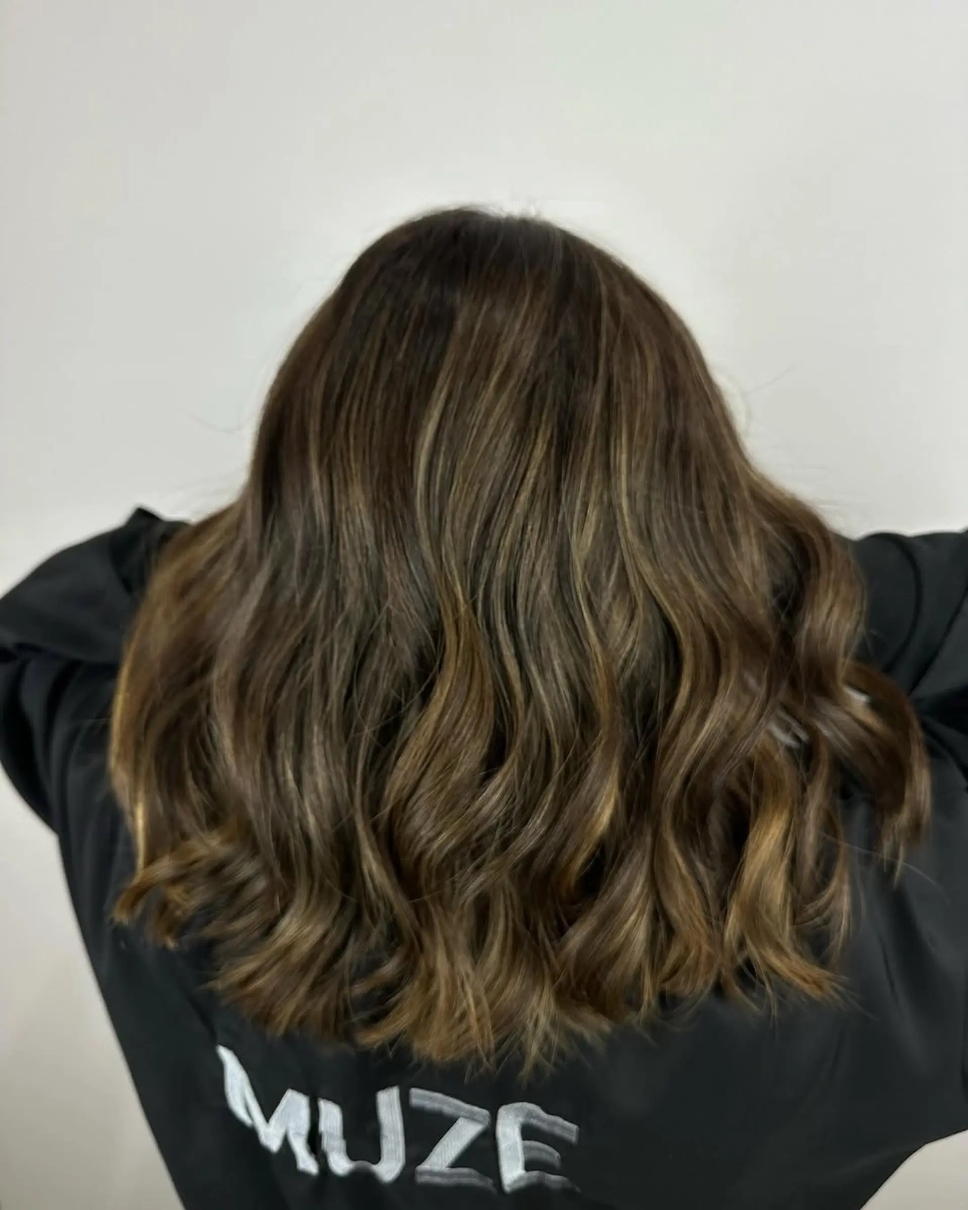A soft, dimensional balayage featuring cool ash brown tones blended into a natural dark brown base. 1
