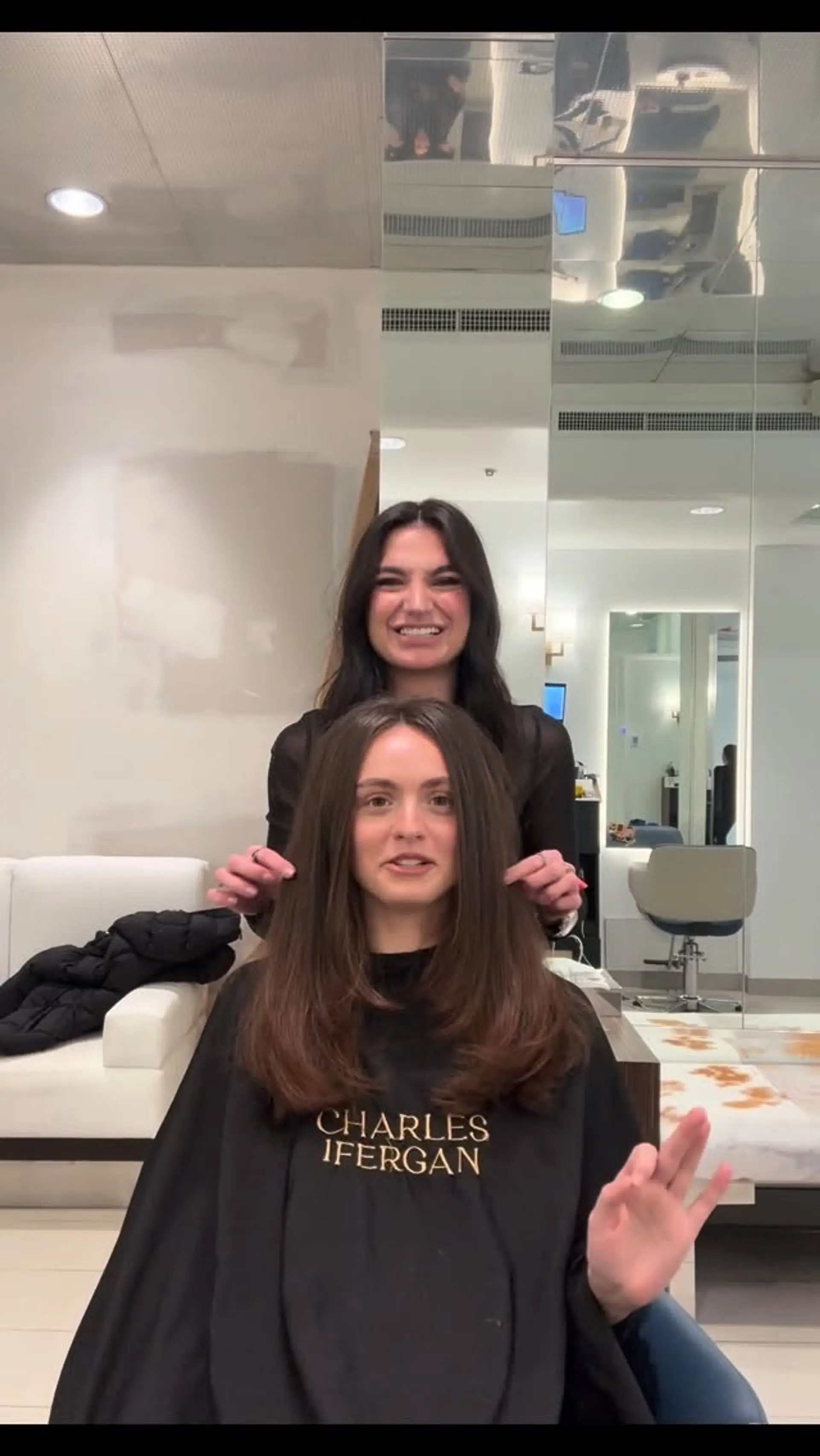 A sleek medium-length layered cut styled with a smooth blowout and soft inward-curling ends. 1