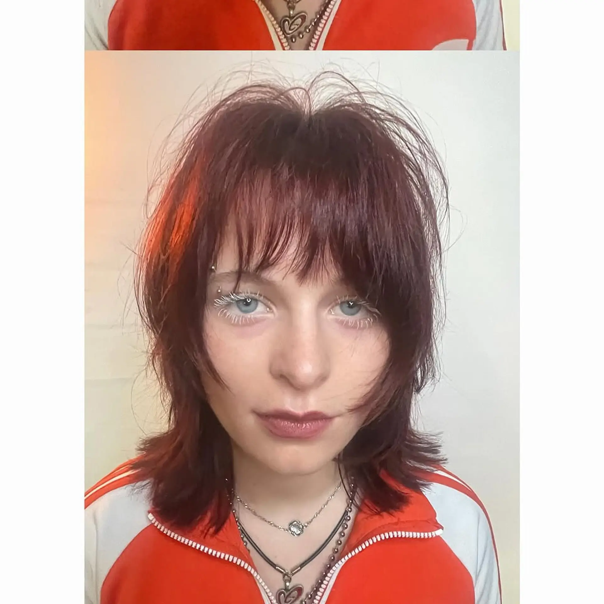 A layered, textured shag haircut featuring wispy bangs and a voluminous, piecey aesthetic with a deep red auburn hue. 1