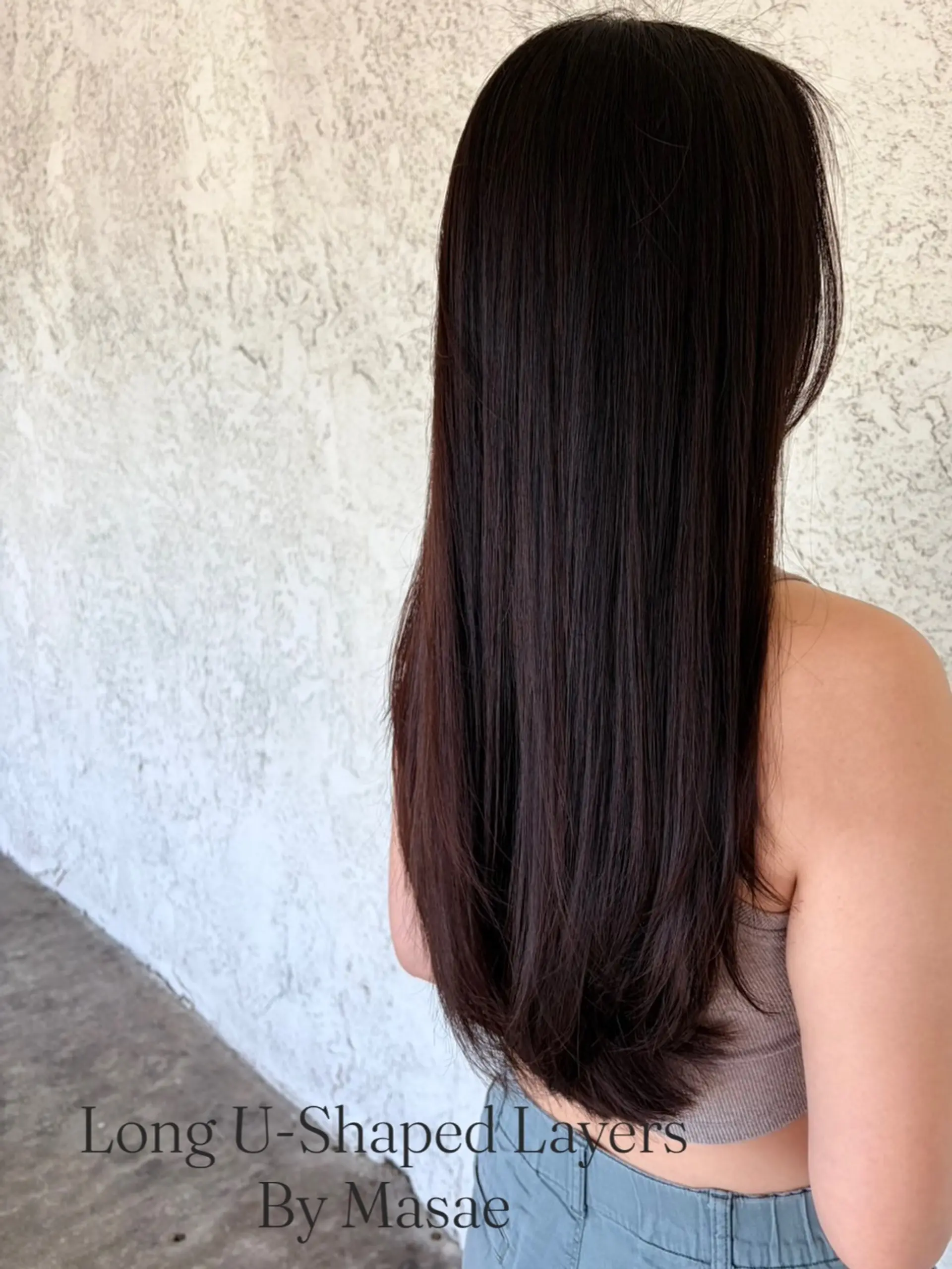 Long, glossy dark hair shaped into gentle U-cut layers with soft movement at the ends. 1