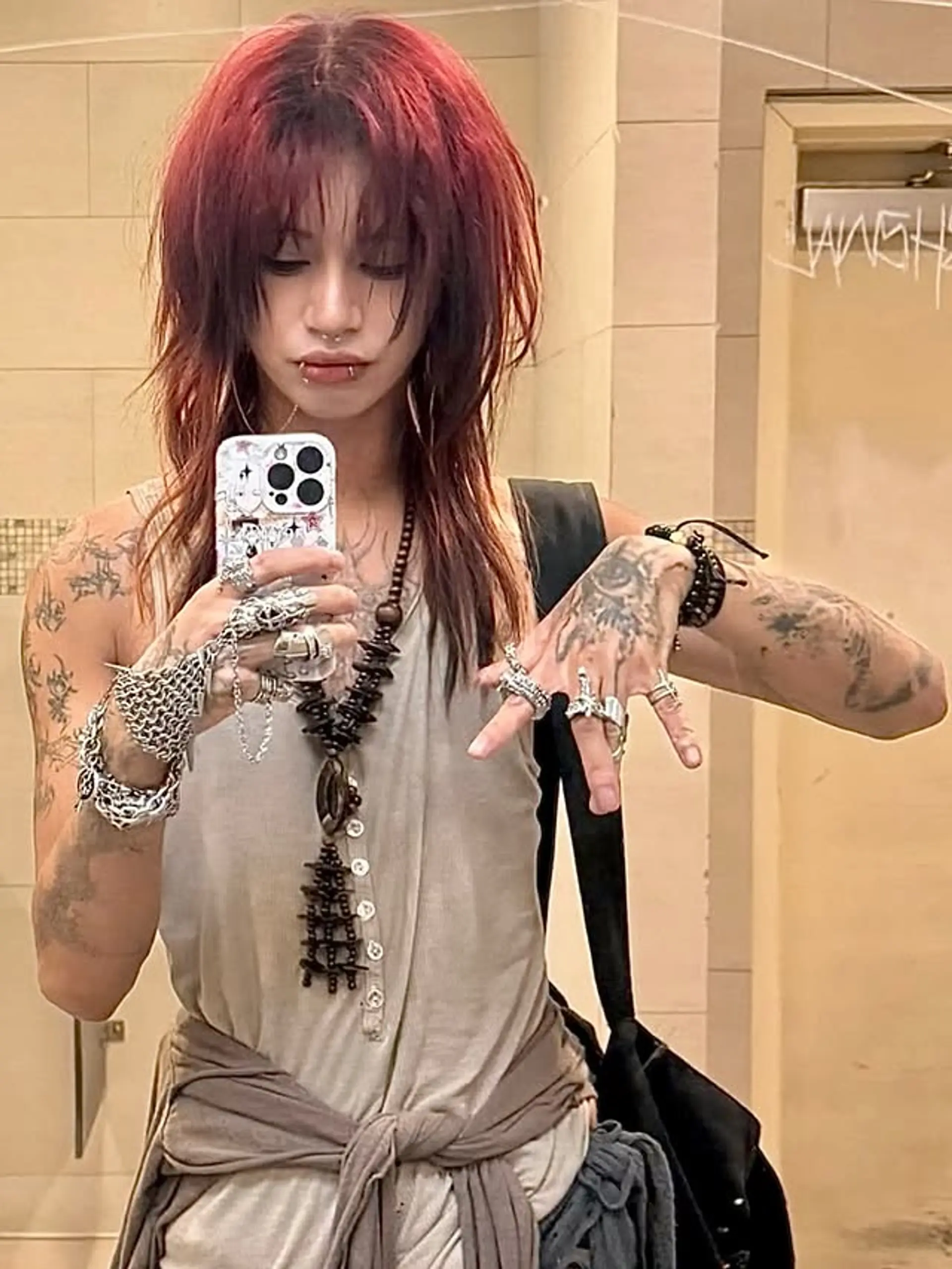 A medium-length shag haircut with textured layers and choppy bangs. 1