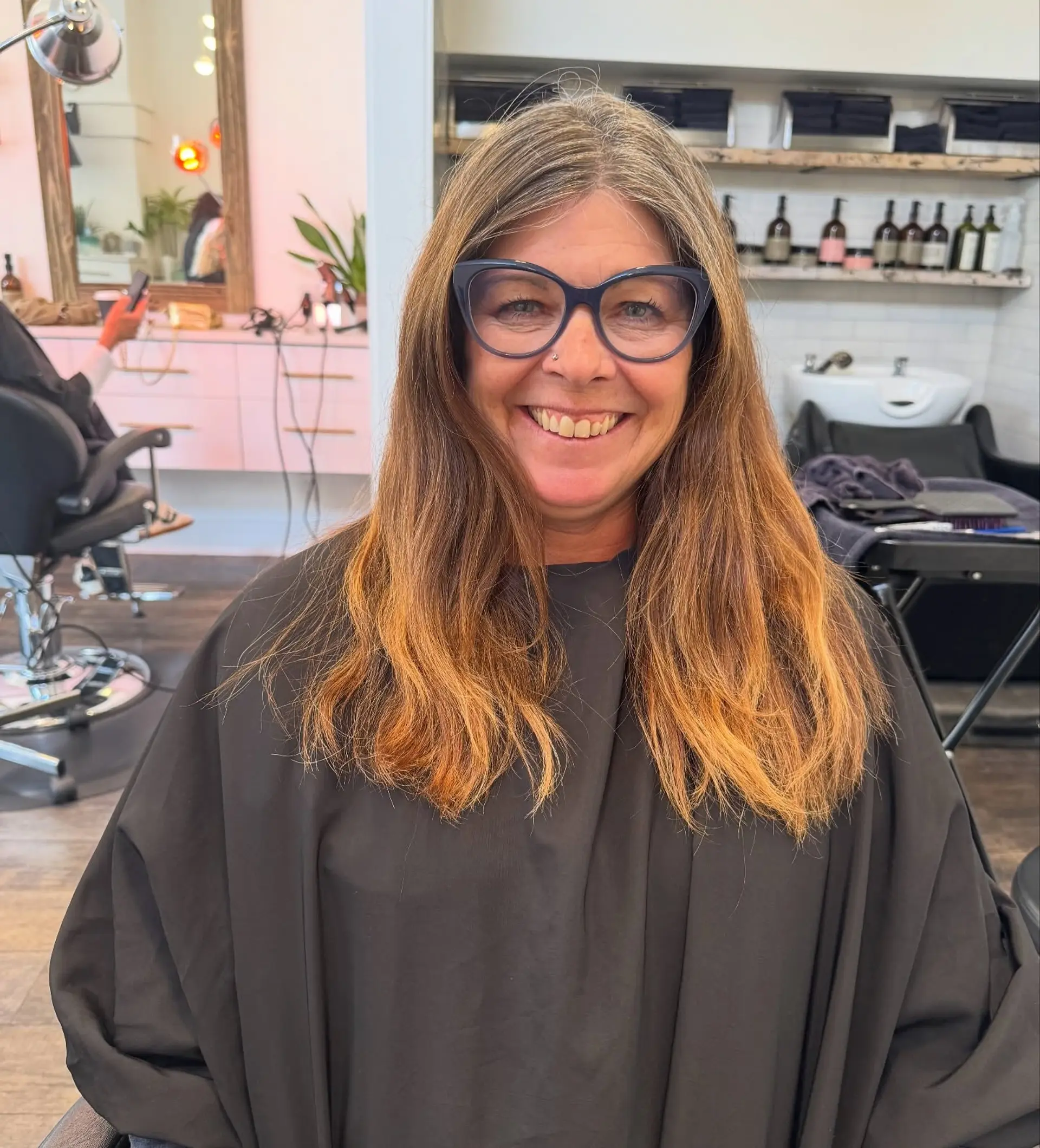 A long layered haircut with natural texture, soft volume, and center-parted face-framing pieces. 1