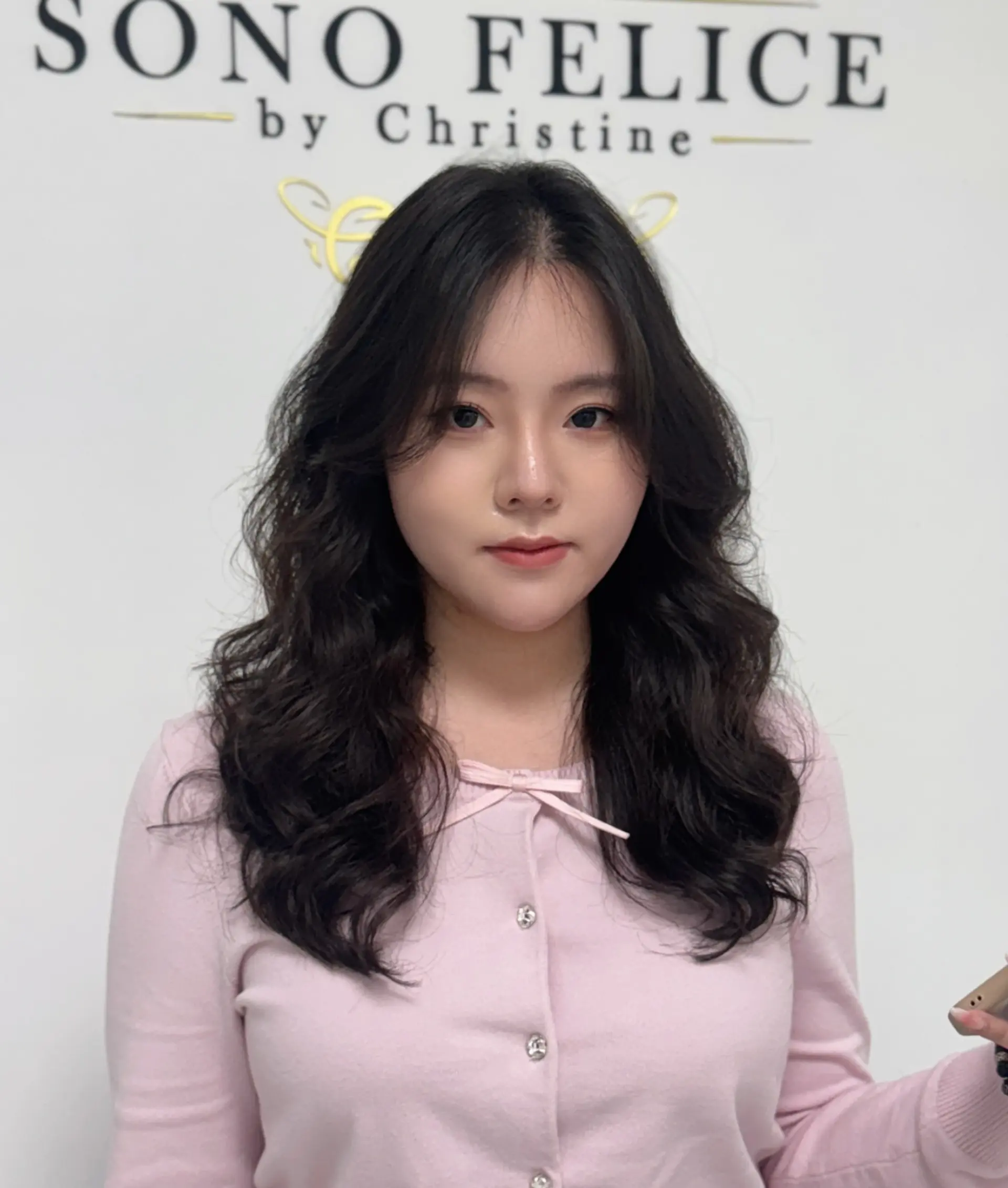 A long wavy hairstyle with face-framing layers for added volume and movement. 1