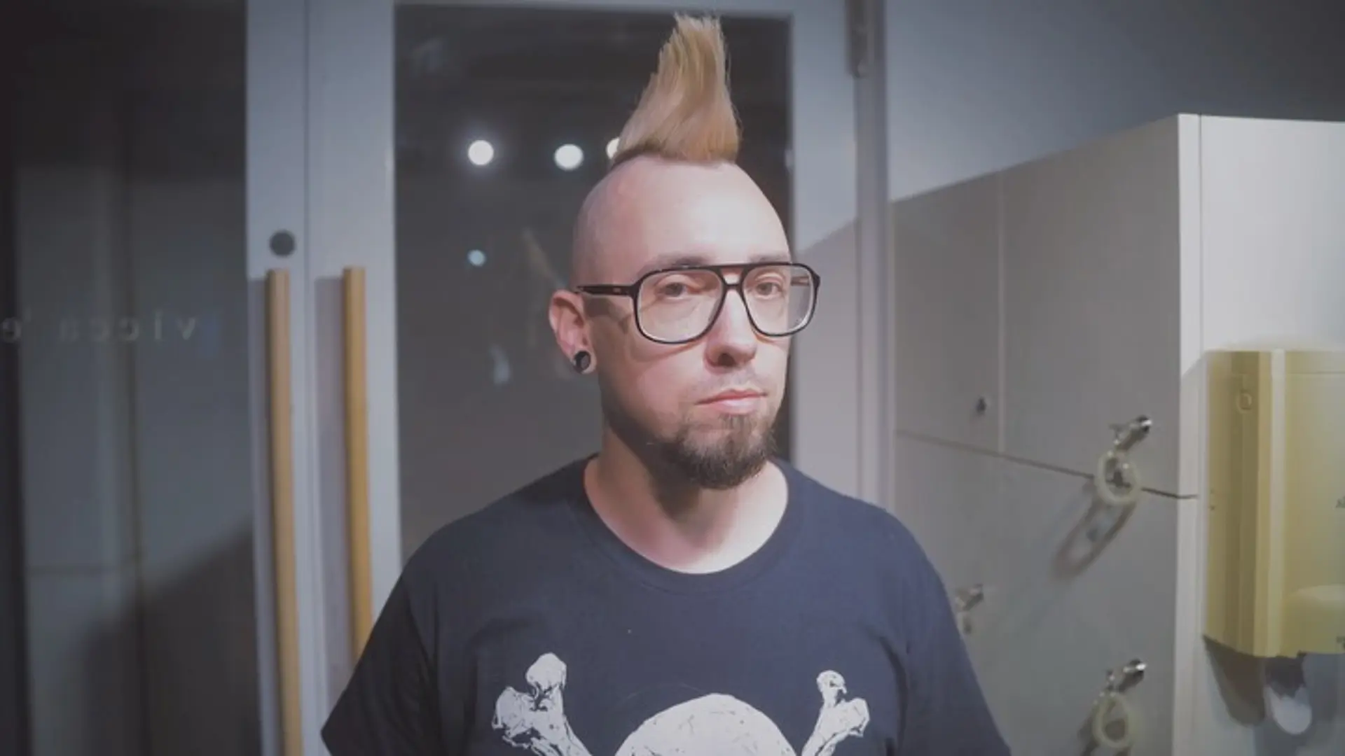 A light blonde mohawk styled vertically with cleanly shaved sides. 1