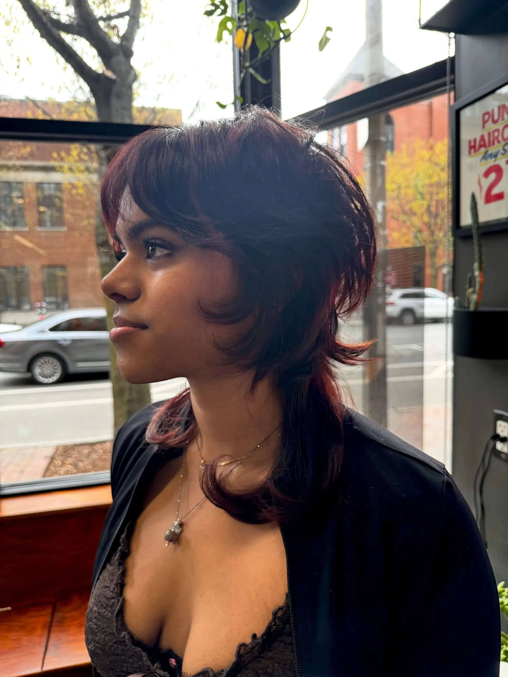 A layered jellyfish cut featuring a rounded, voluminous top layer with flipped ends, wispy curtain bangs, and longer bottom layers. 1