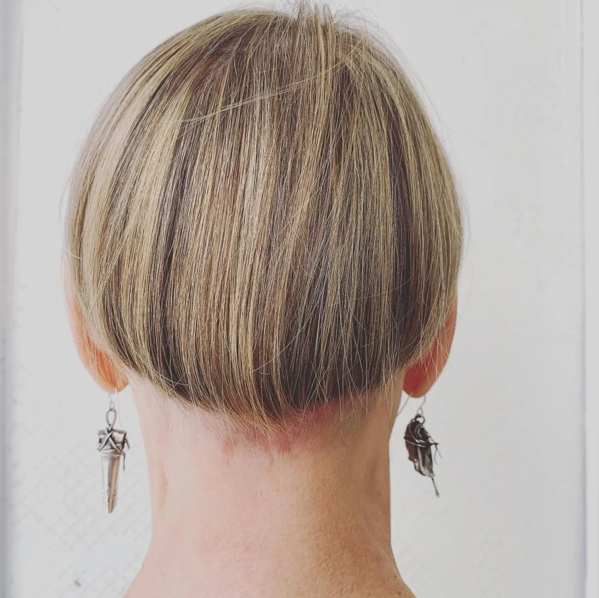 A short, straight bob with a blunt fringe and a clean finish, exuding a modern yet retro charm. 3