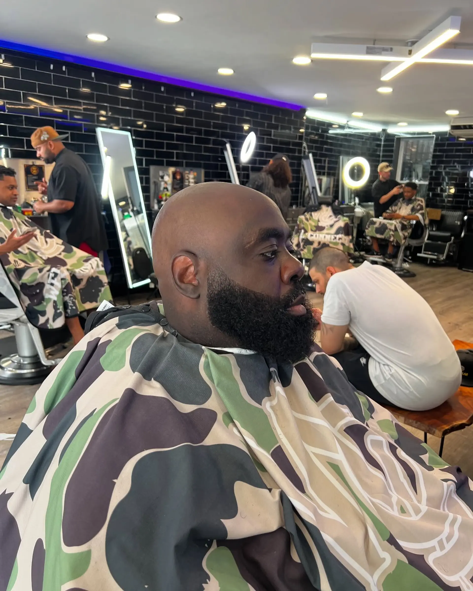 A completely clean-shaved bald head paired with a sculpted, full, neatly lined-up beard. 1
