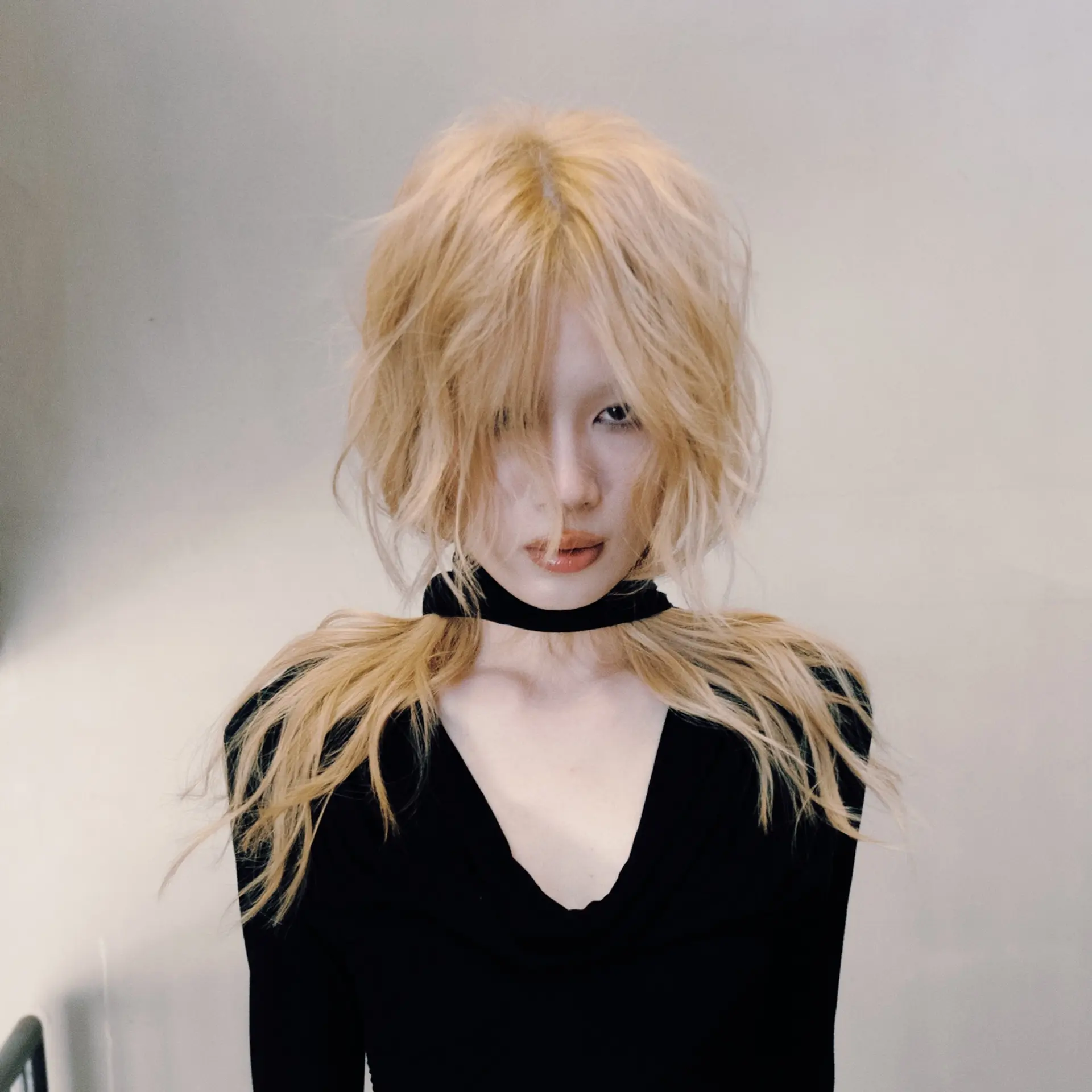 A heavily textured light blonde shag with full, wispy bangs and feathered layers framing the face. 1
