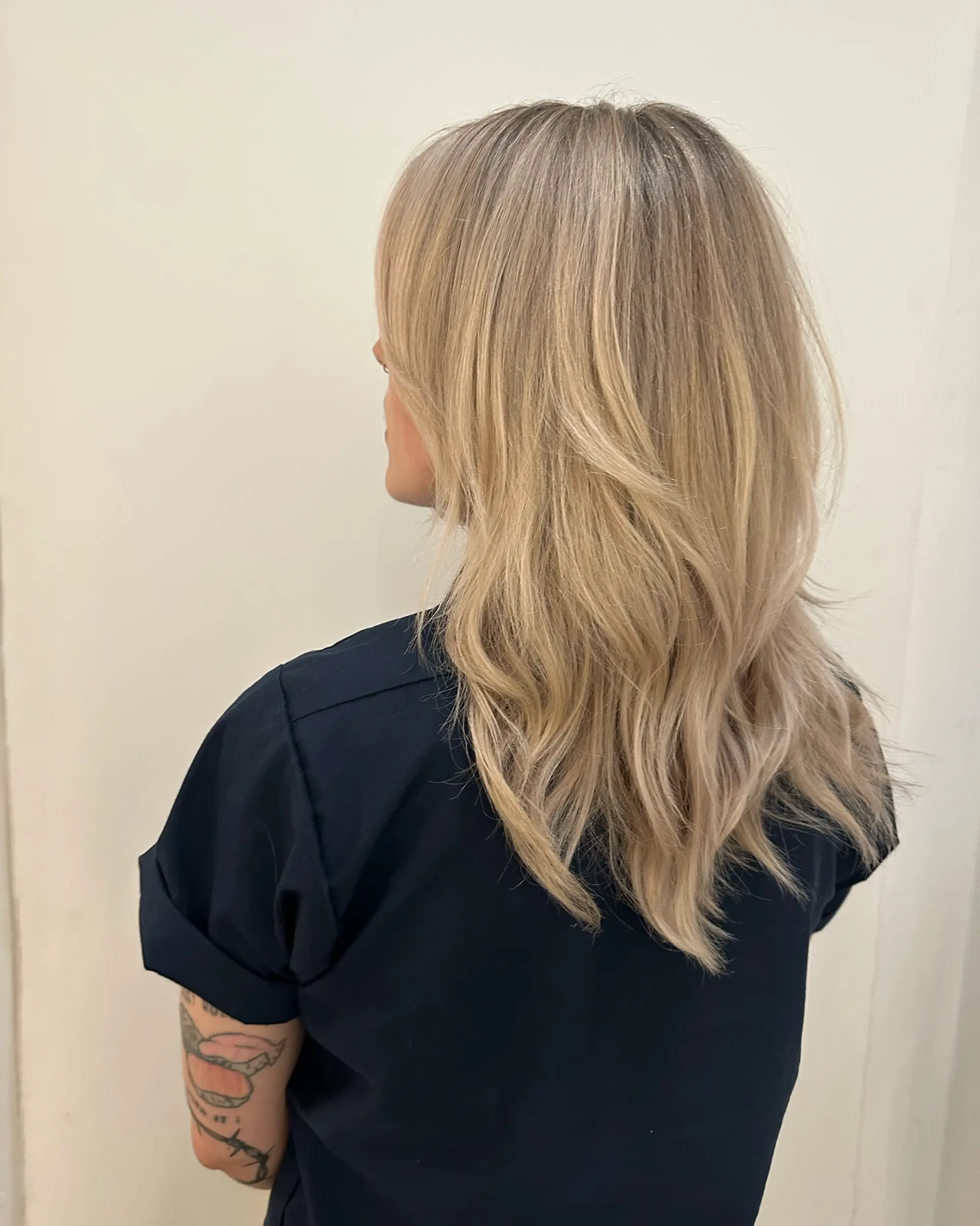 Long, cool-toned dimensional blonde hair cut with flowing soft layers. 1
