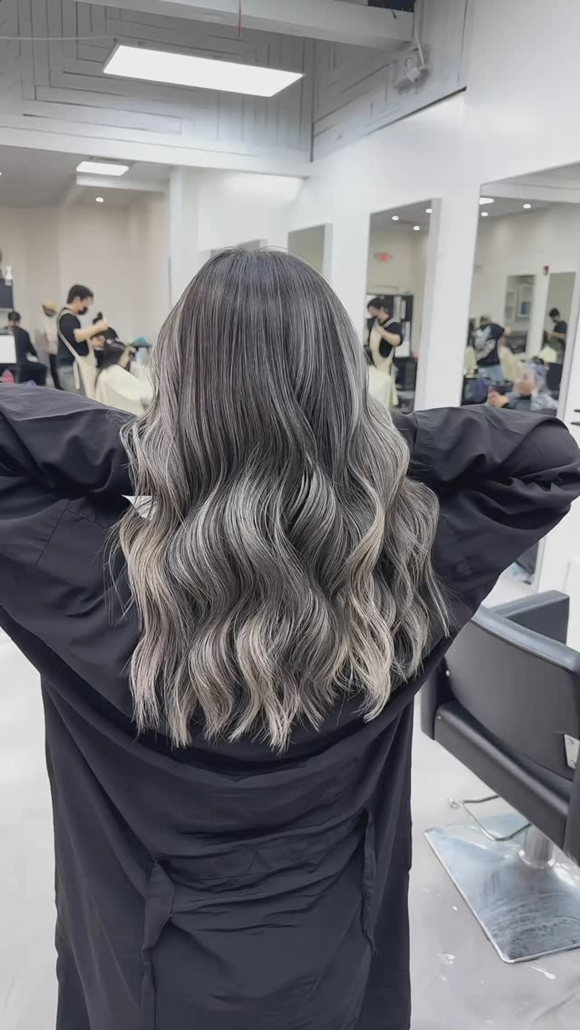 Long hair featuring an ash silver and cool-toned balayage, styled with soft, cascading waves. 1