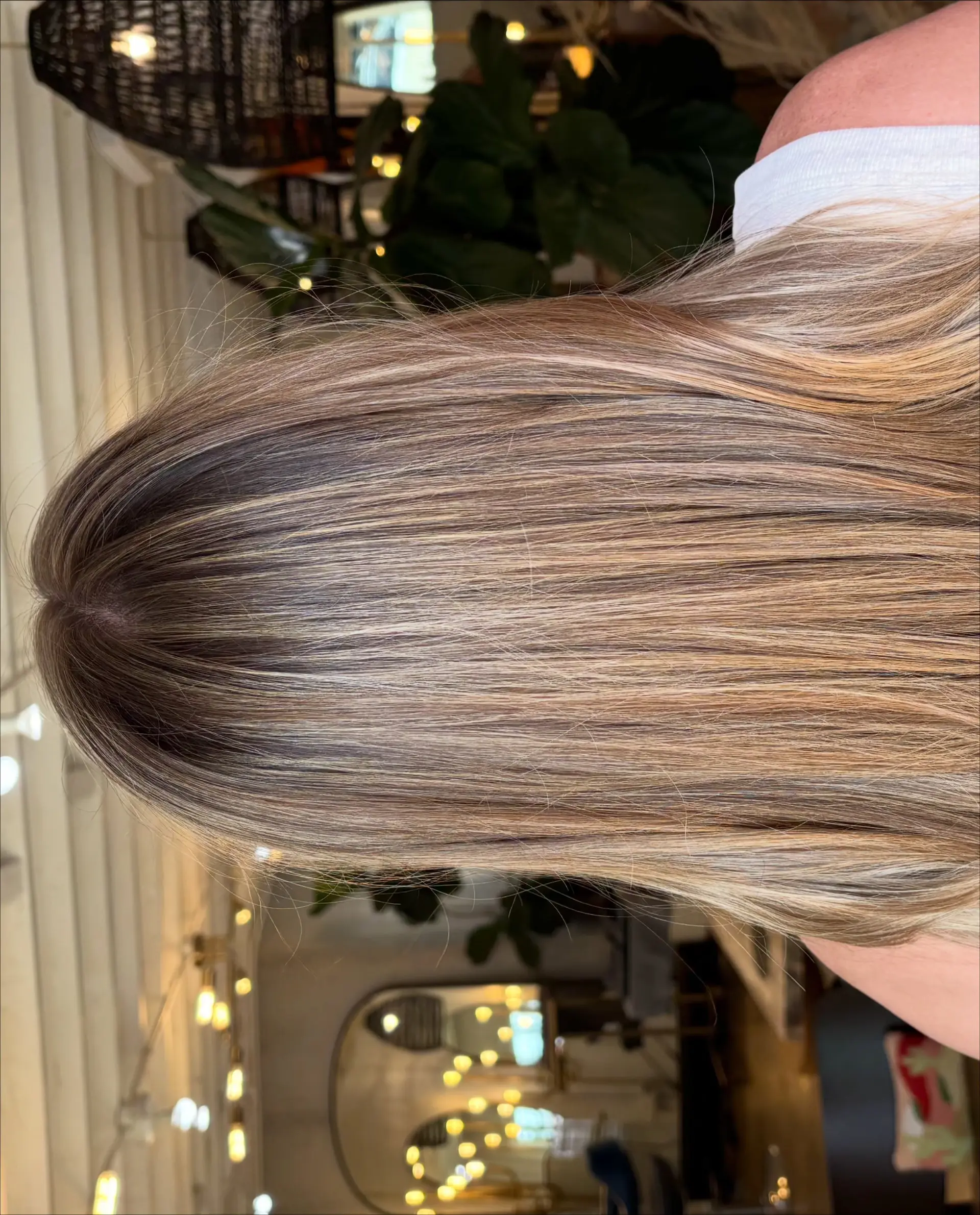 Long straight bronde hair featuring soft, blended highlights and a smooth blowout finish. 1