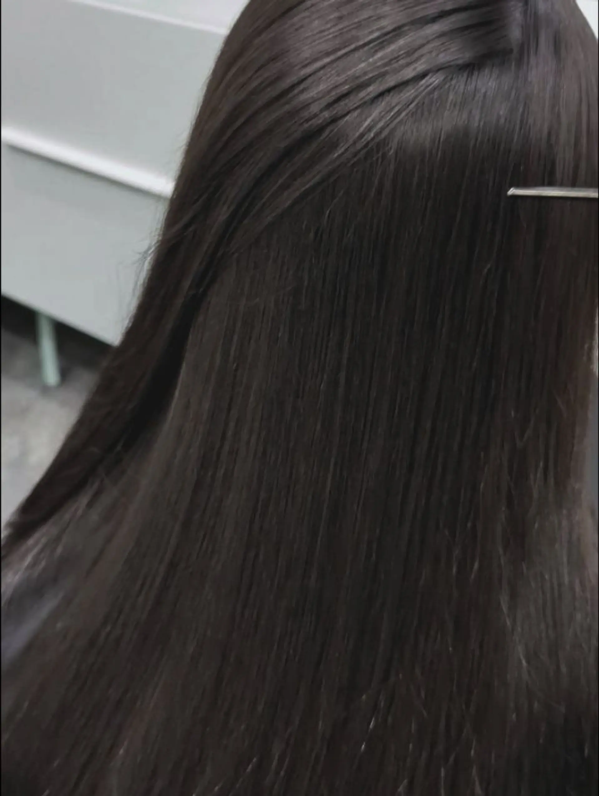 Long, pin-straight dark brown hair showcasing a smooth, glossy, and frizz-free finish. 1