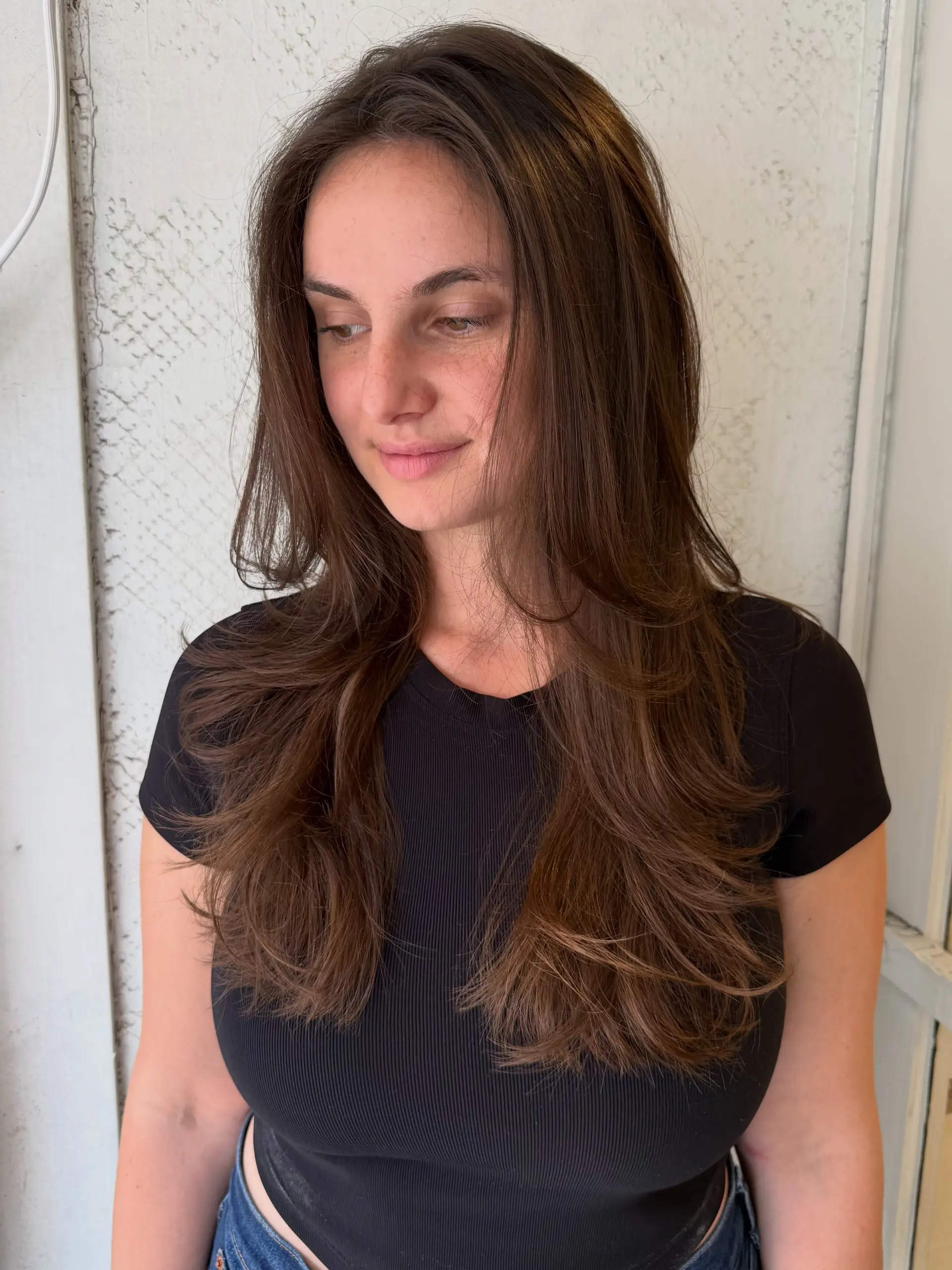 Long chocolate brown hair featuring feathered face-framing layers and soft, dimensional body. 1