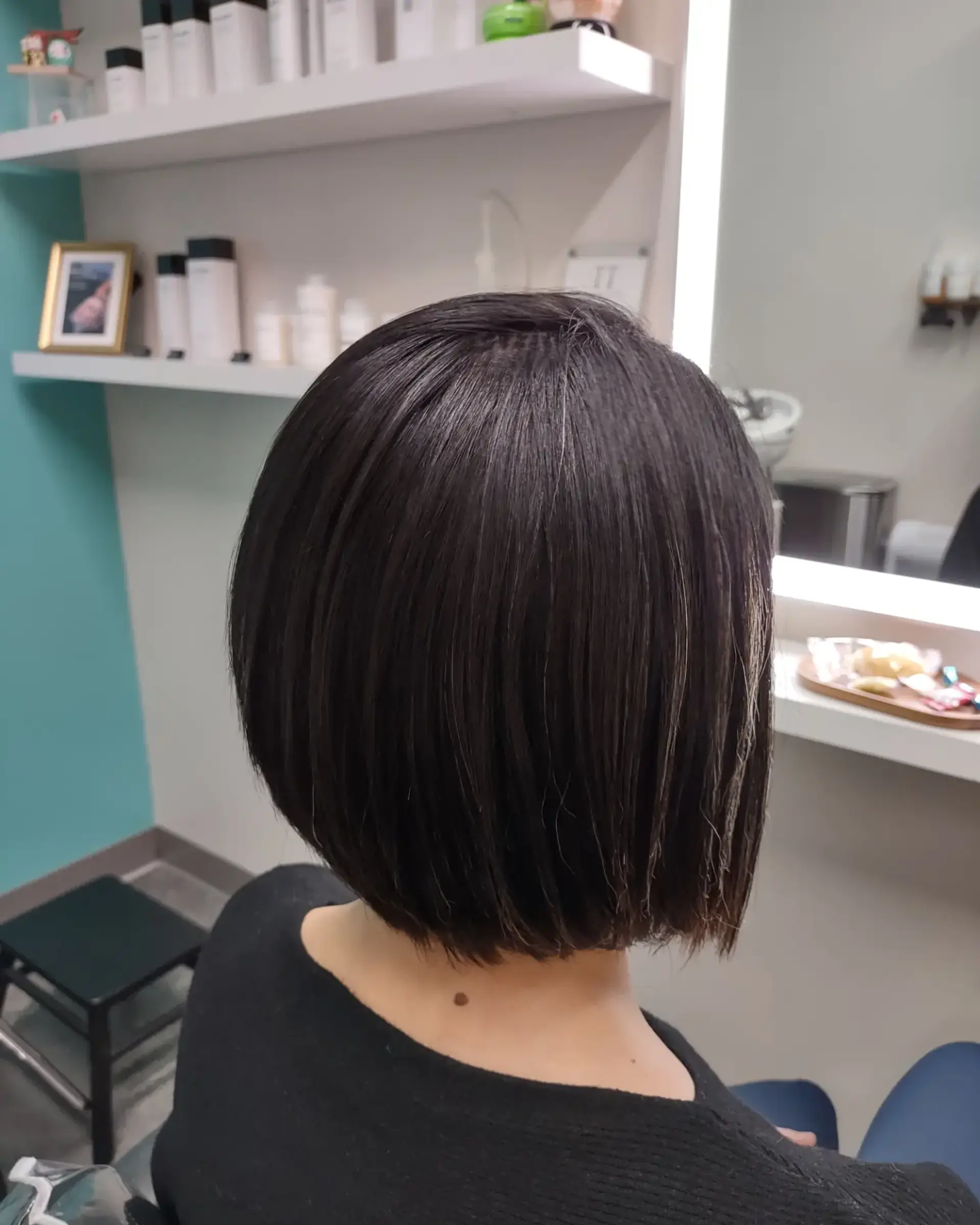 A sleek, straight chin-length blunt bob with an ultra-smooth, glossy finish. 1