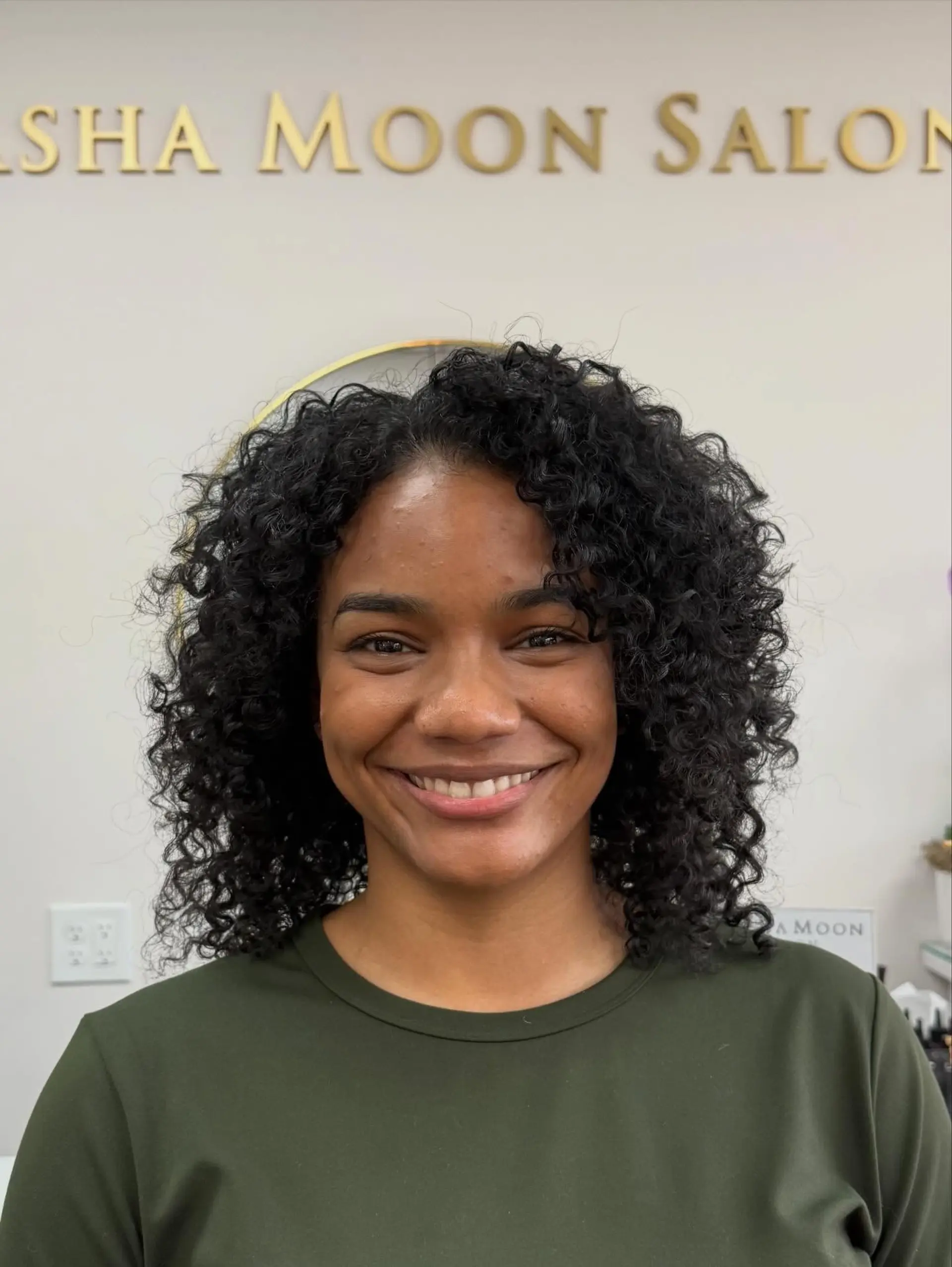 Shoulder-length rounded cut showcasing bouncy, well-defined coils with an off-center part. 1