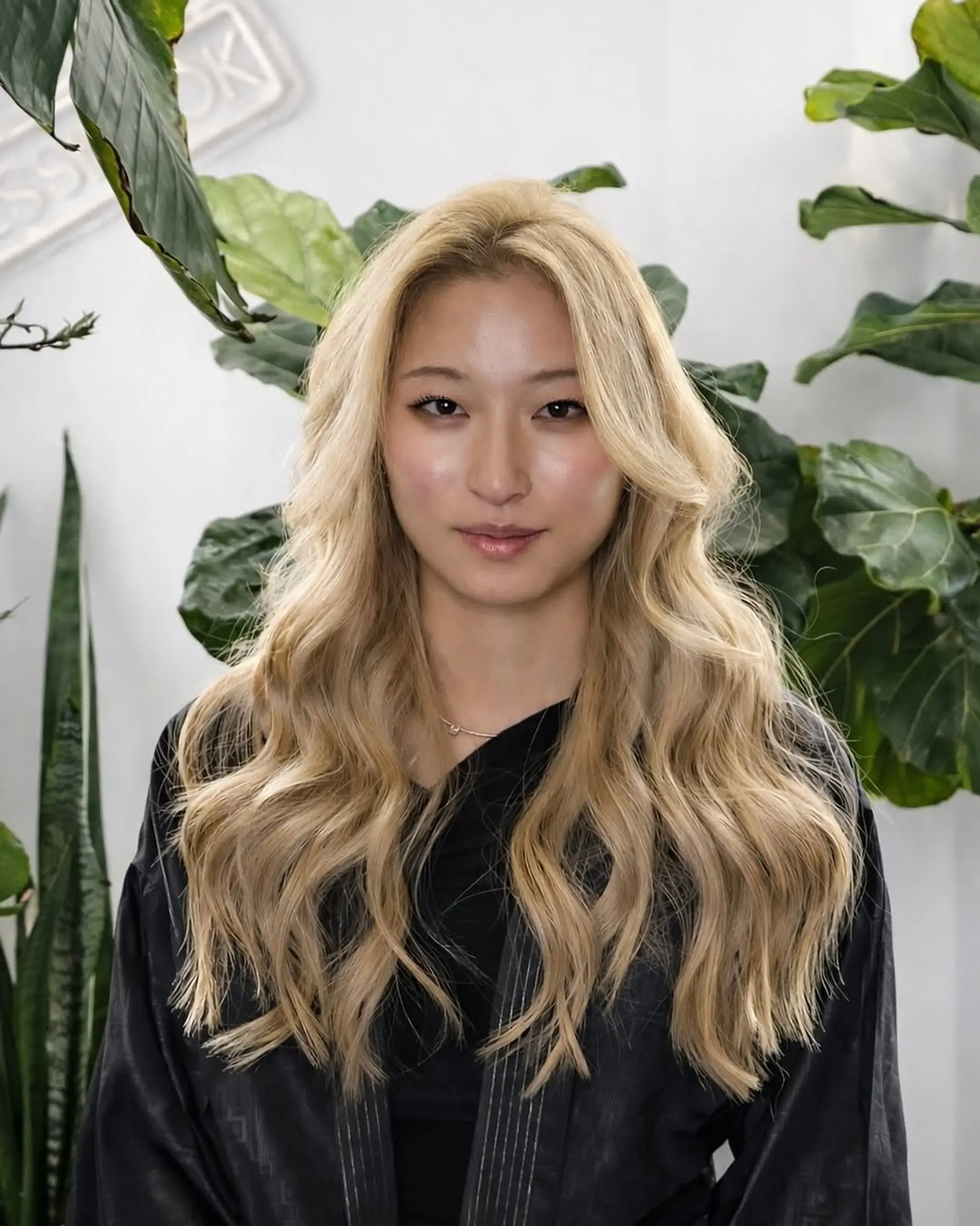 Long hair styled in soft, loose beach waves with face-framing layers and a vibrant golden blonde color. 1