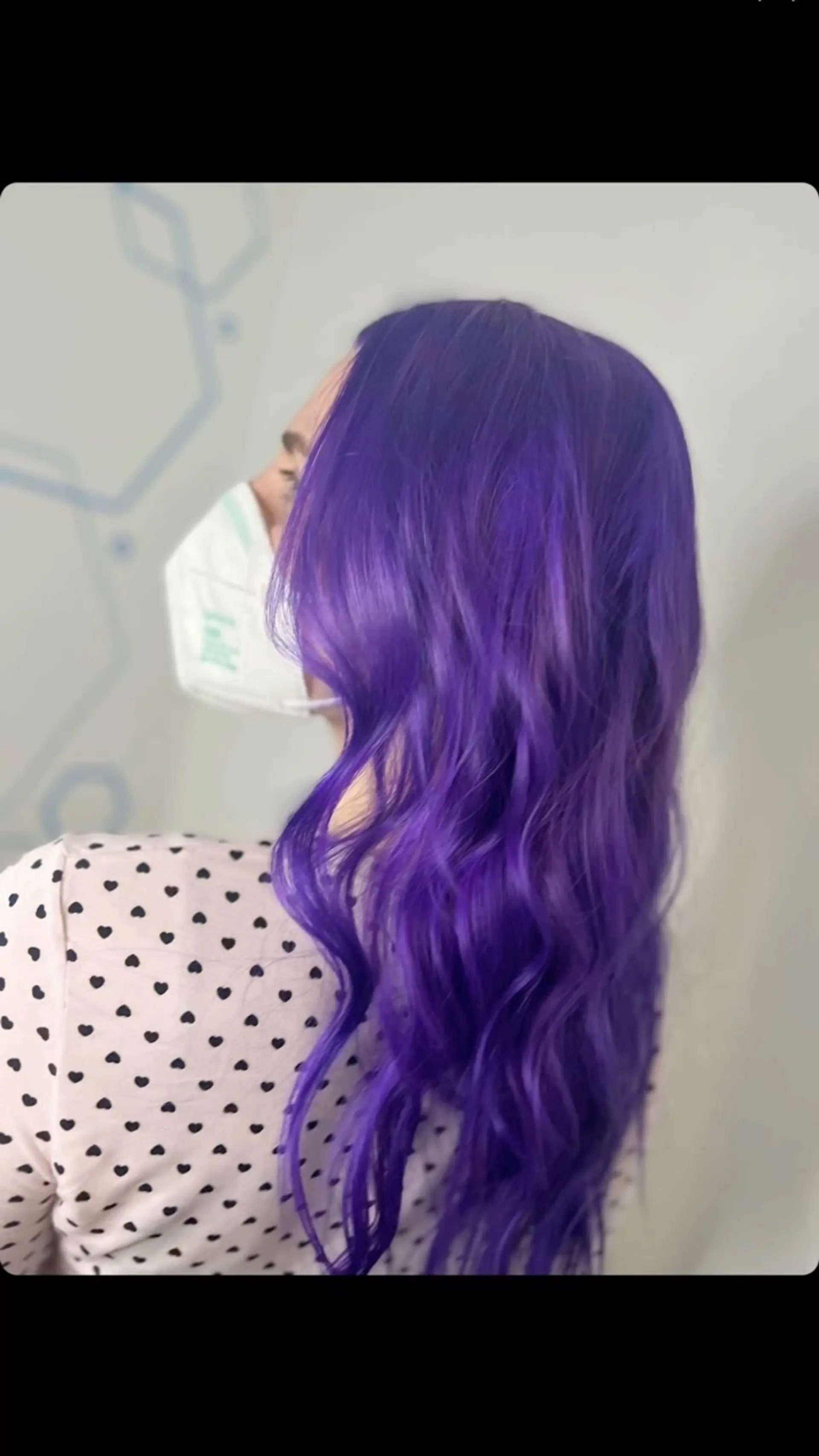 Vibrant electric purple all-over hair color styled in soft, loose waves. 1