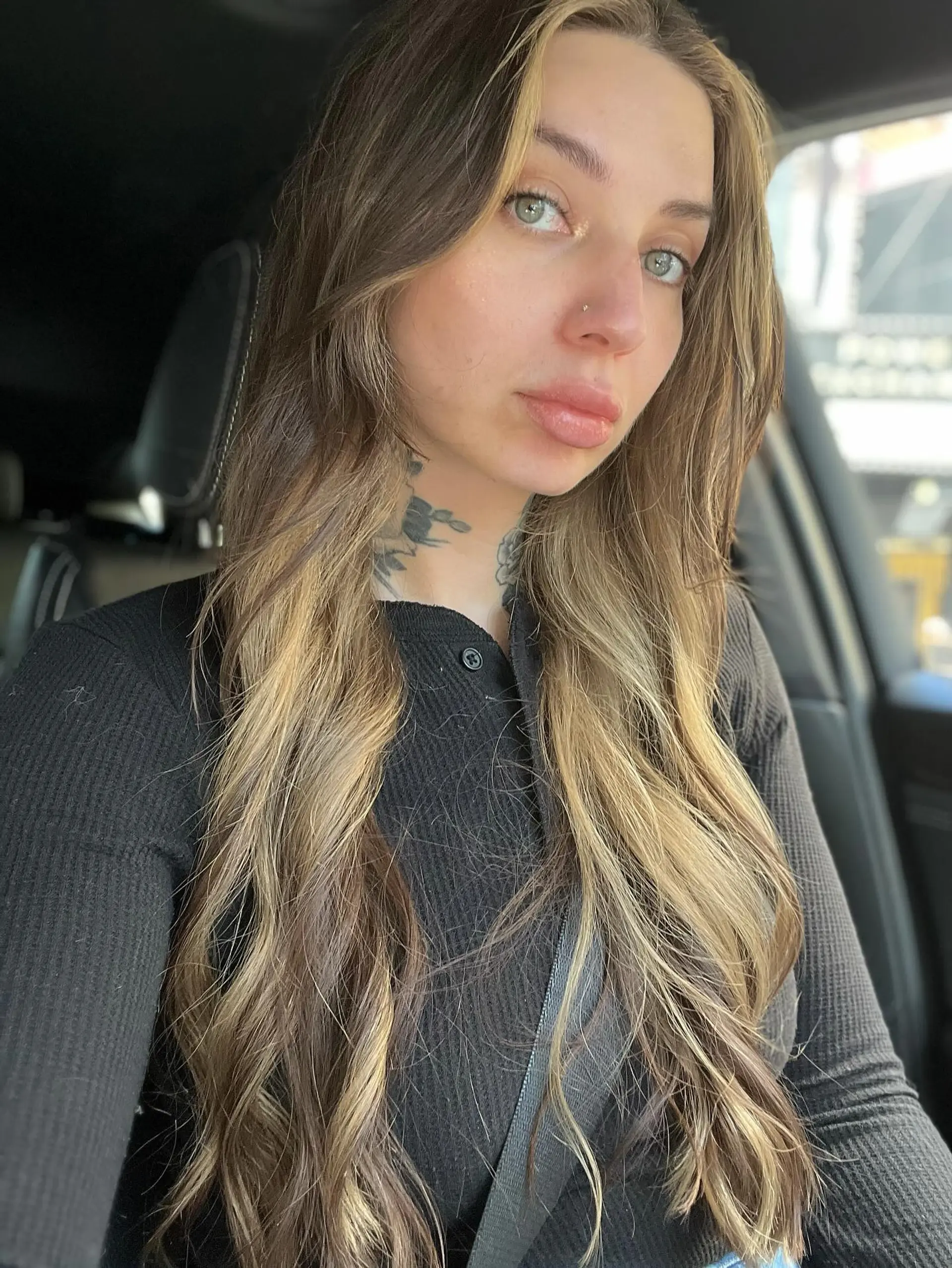 Long wavy brunette hair highlighted with bright blonde face-framing pieces and dimension throughout. 1