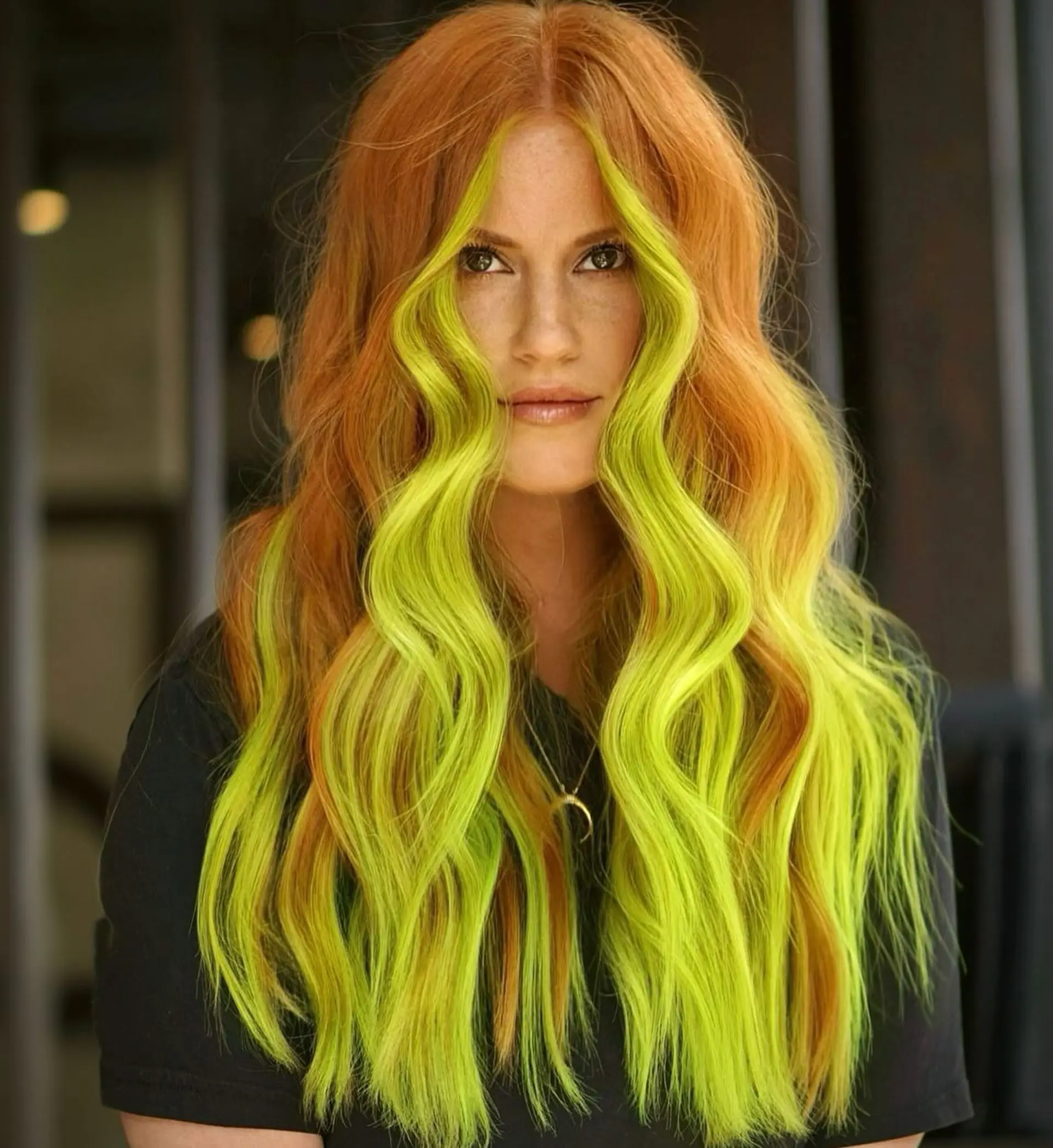 Long cascading copper waves highlighted by an electric neon chartreuse-green face-framing money piece. 1