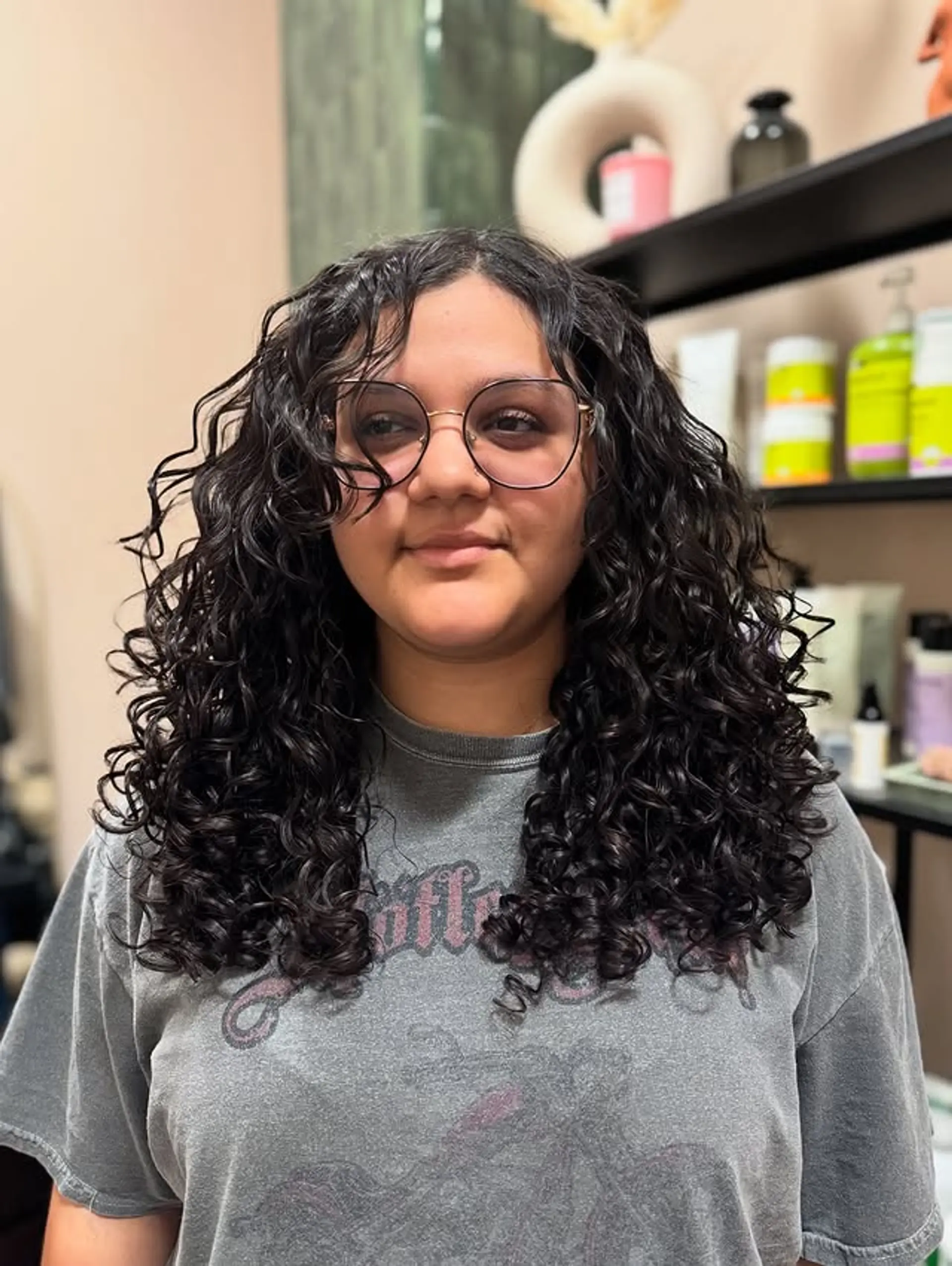 A medium-length curly hairstyle with defined, natural curls. 1