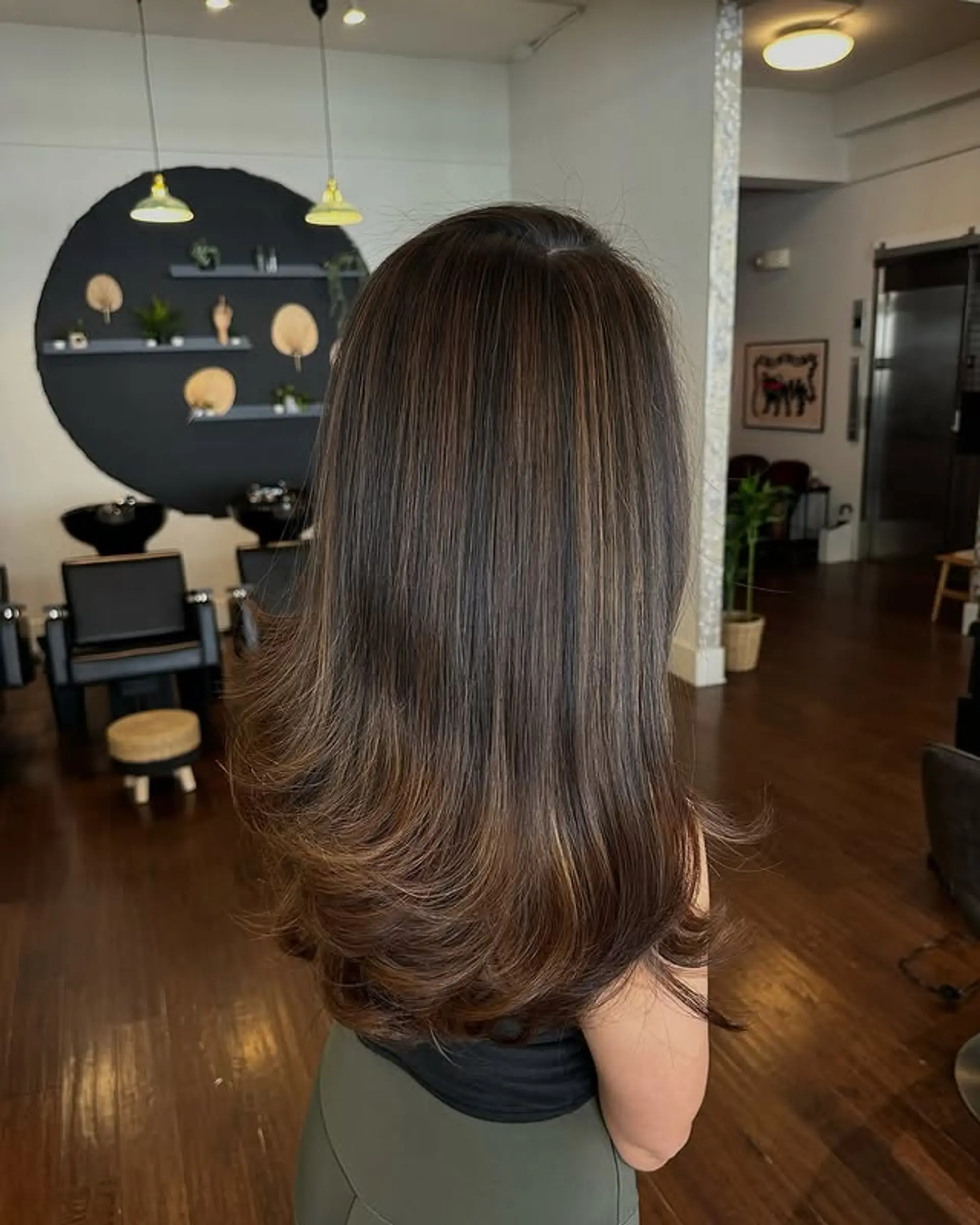 Long layered hairstyle with subtle balayage highlights. 1